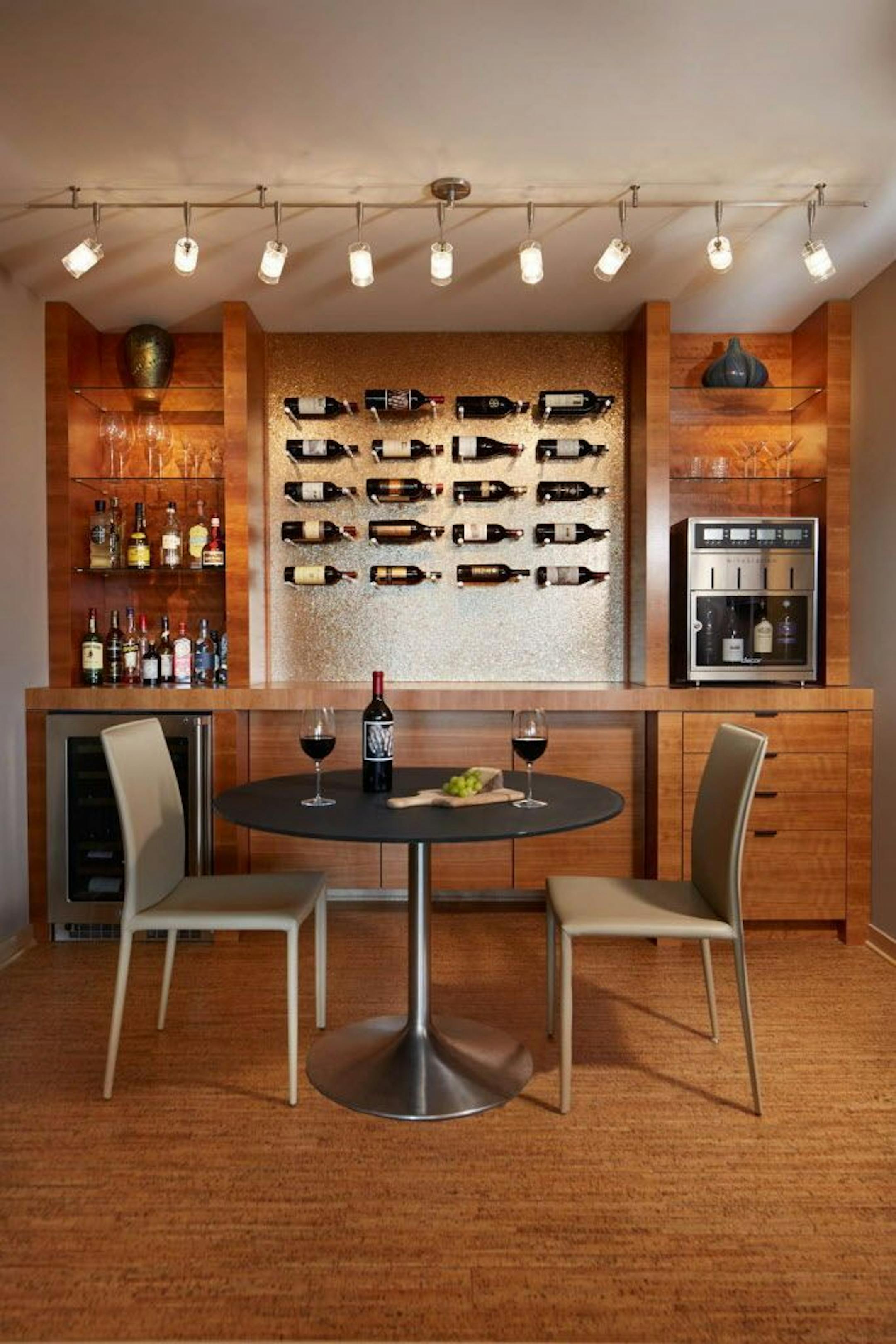 Mica-flecked wallpaper and a wine display system by Vin De Garde in the cozy wine room.