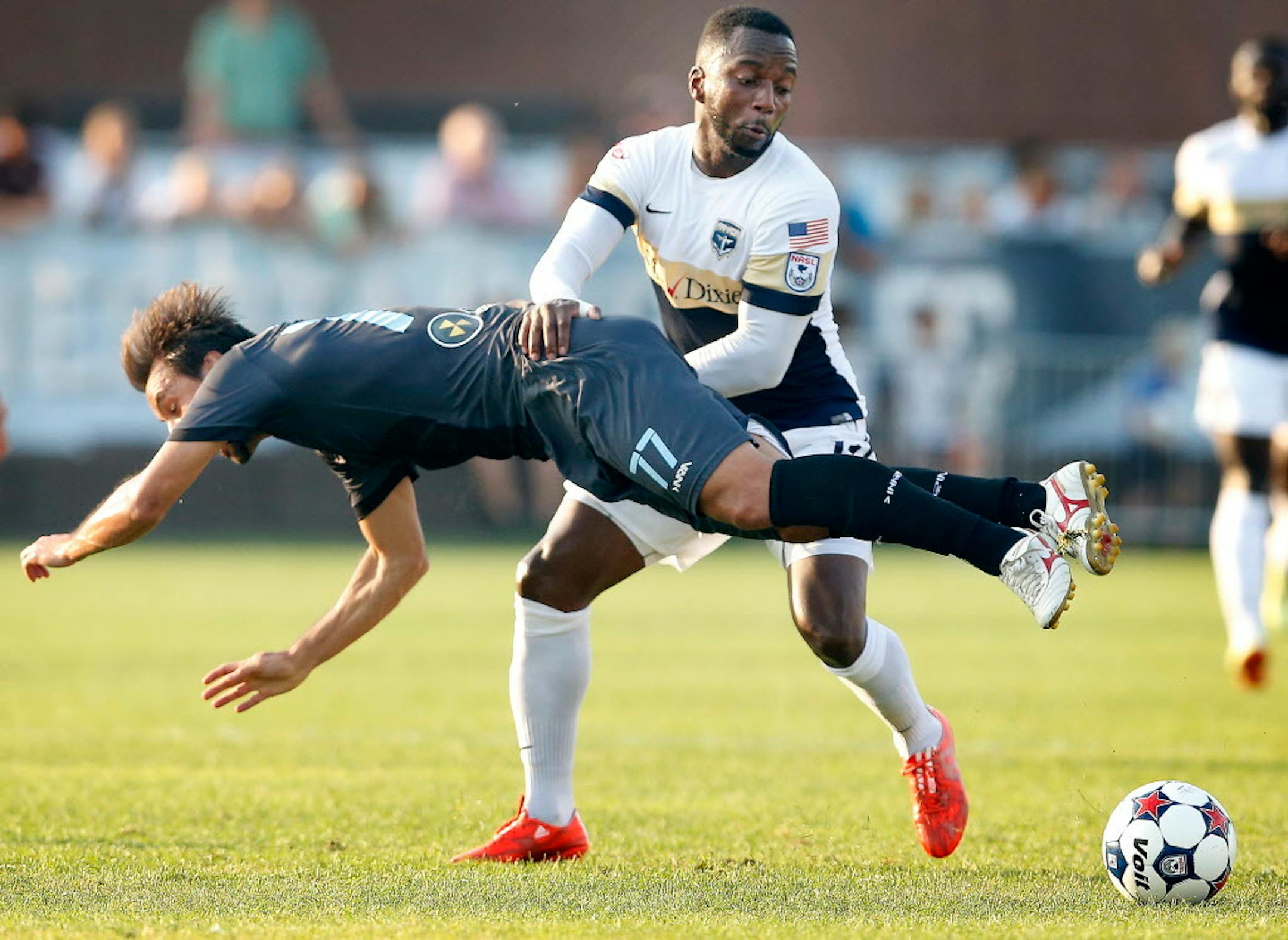 Juliano Vicentini (77) of Minnesota United FC and Jemal Johnson (11) fought for the ball in the first half. ] CARLOS GONZALEZ cgonzalez@startribune.com - July 15, 2015, Blaine, MN, National Sports Center Stadium, Soccer, Minnesota United FC vs. Jacksonville
