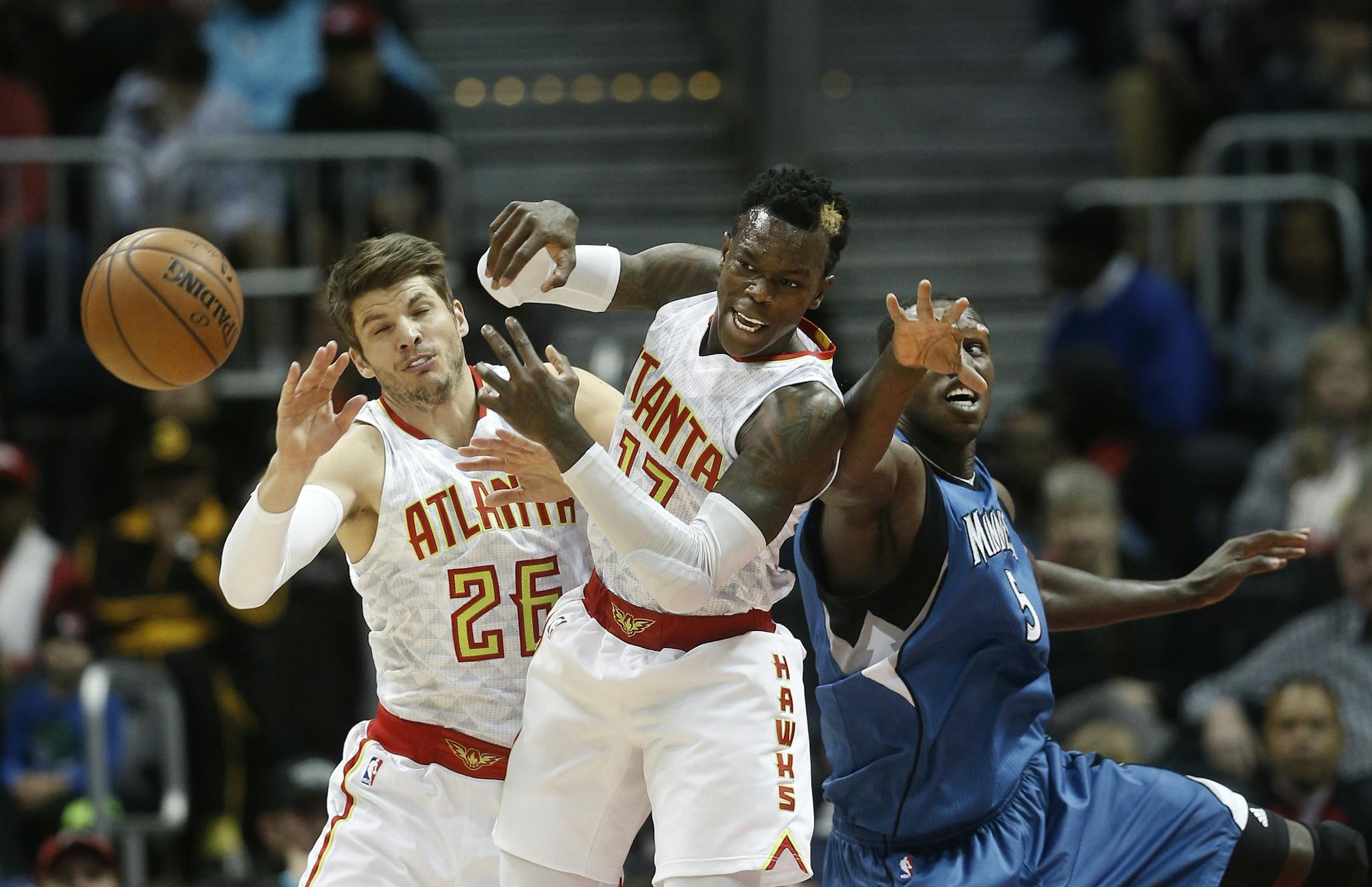 Atlanta Hawks guards Dennis Schroder (17) and Kyle Korver (26) battle Minnesota Timberwolves forward Gorgui Dieng (5) for a loose ball in the first half of an NBA basketball game Wednesday, Dec. 21, 2016, in Atlanta.