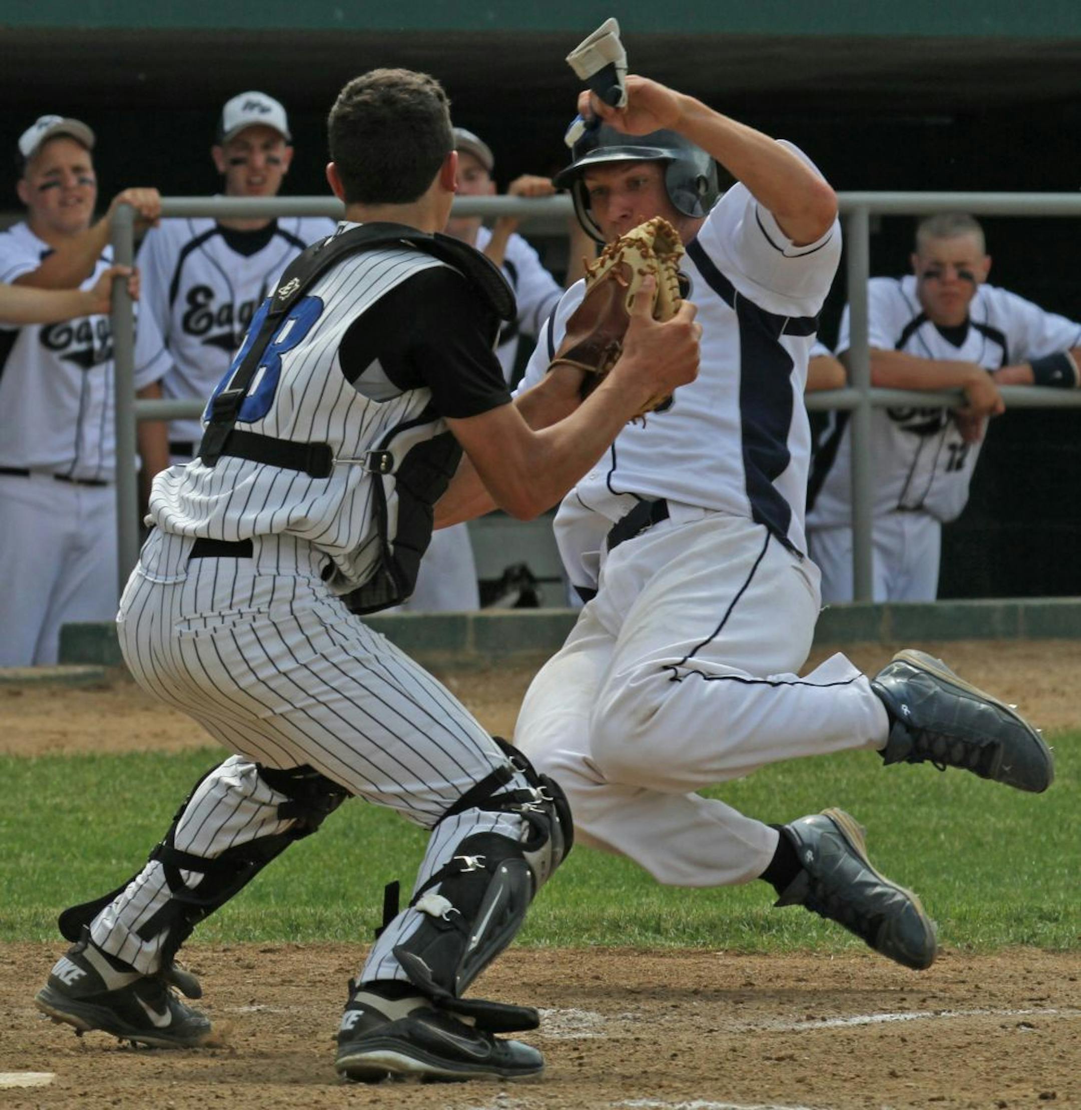 Boys Class 1A Baseball State Semifinals. Eden Valley-Watkins vs Red Lake County (left to right) Red Lake County Catcher Wyatt Casavan was in position to make the tag on Eden Valley-Watkins Brendon Ashton for an out in 3rd inning action.