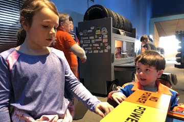 Eden and Abraham Cleberg prepare to race Hot Wheels cars down a two-lane racetrack Monday, Jan. 20.