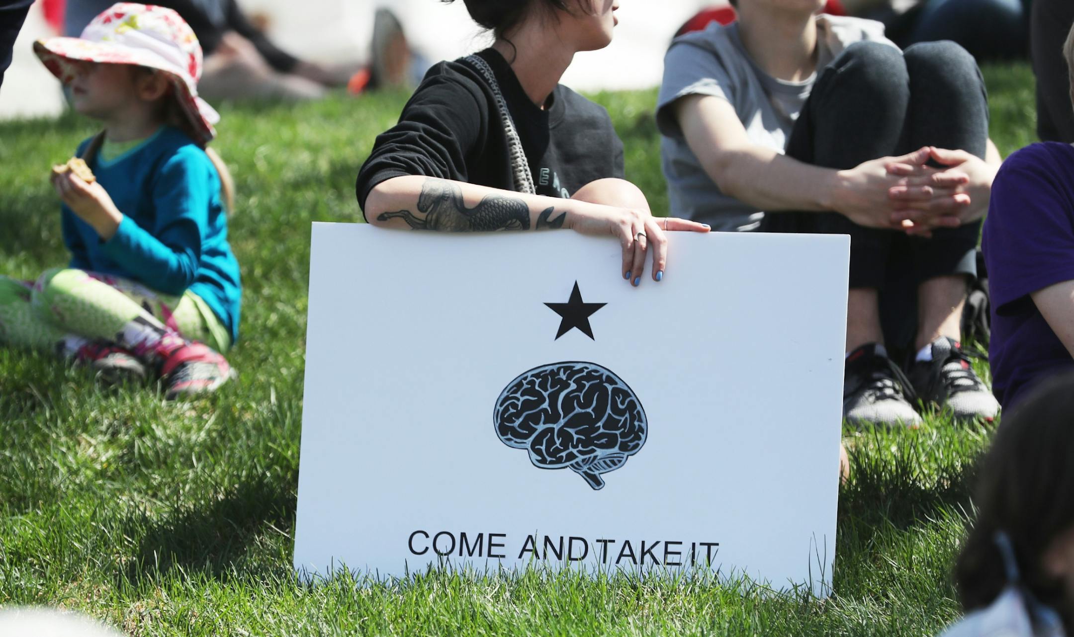 March for Science moved from the start at Cathedral Hill Park to State Capitol, with an estimated 10,000 or more joining to champion the role of science in American life. Here, marchers rested on the lawn during the March for Science near the State Capitol Mall Saturday, April 22, 2017, in St. Paul, MN.