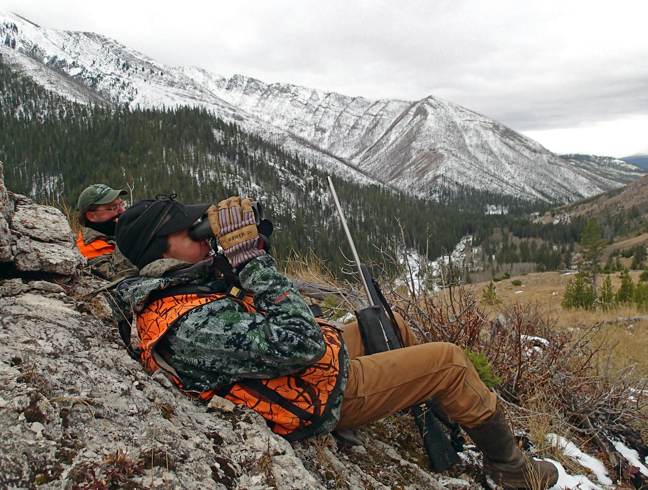 Guide Josh Carlbom of Sun Canyon Lodge glasses for elk on a distant mountainside while hunter Peter Stanford of Milwaukee looks on. The two were in the 1-milliion-acre Bob Marshall Wilderness at an elevation of about 6,500 feet. Temperatures hovered in the single digits at night, rising to the 20s in daytime.