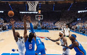 Timberwolves guard Anthony Edwards (5) shoots off balance while defended by Oklahoma City guard Luguentz Dort (5) in the first half of Game 5 of their