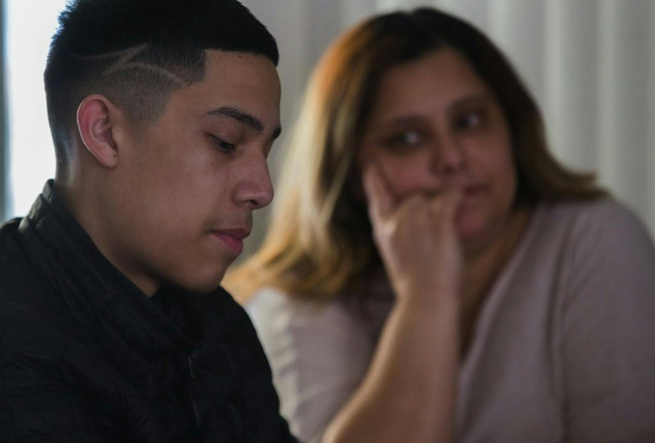 Javier Mercado's mom Julia Cadena, right, listens while her son tells of his harrowing story March 6, 2018, of a home robbery when he was hiding in his parent's closet and robbers were stealing from the family's Des Moines home. His dog, Rex, was shot three times and probably saved Javier's life. Rex lived.