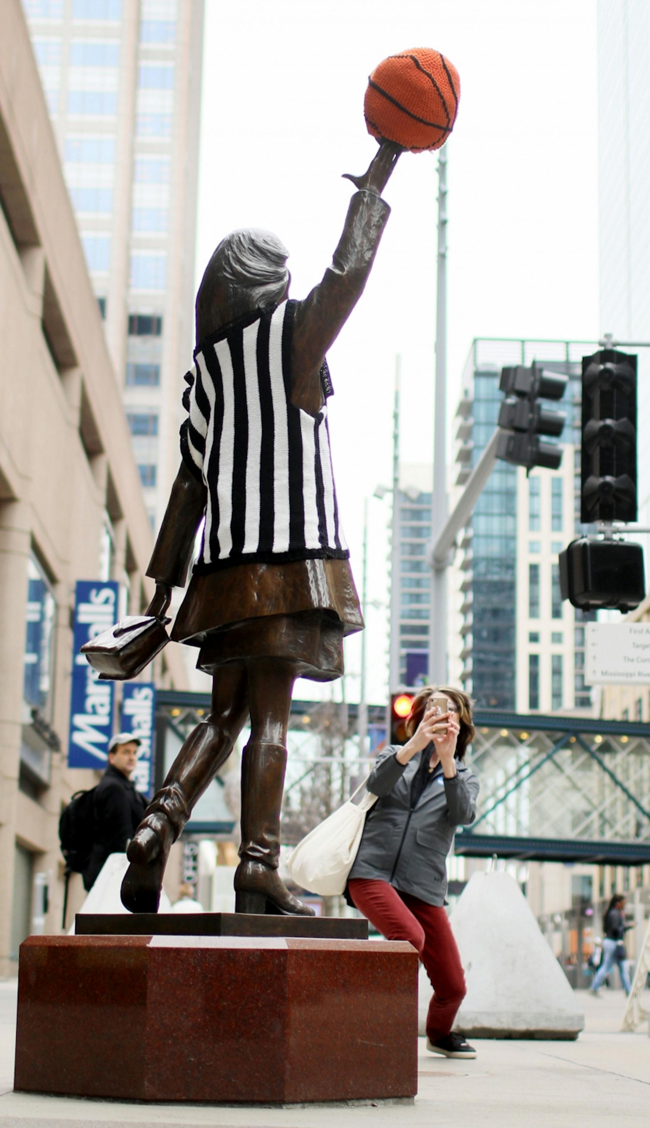 The Mary Tyler Moore statue on the Nicollet Mall appears to have been yarn bombed for the Final Four as her hat was covered in a yarn basketball and torso in a referee's vest, so suggested Kate Mortenson, 2019 Minneapolis Final Four Local Organizing Committee president and CEO, after she photographed the statue Thursday, April 4, 2019, in Minneapolis, MN. "It's a mystery," Mortenson said as to how the faux basketball and ref's outfit came about.