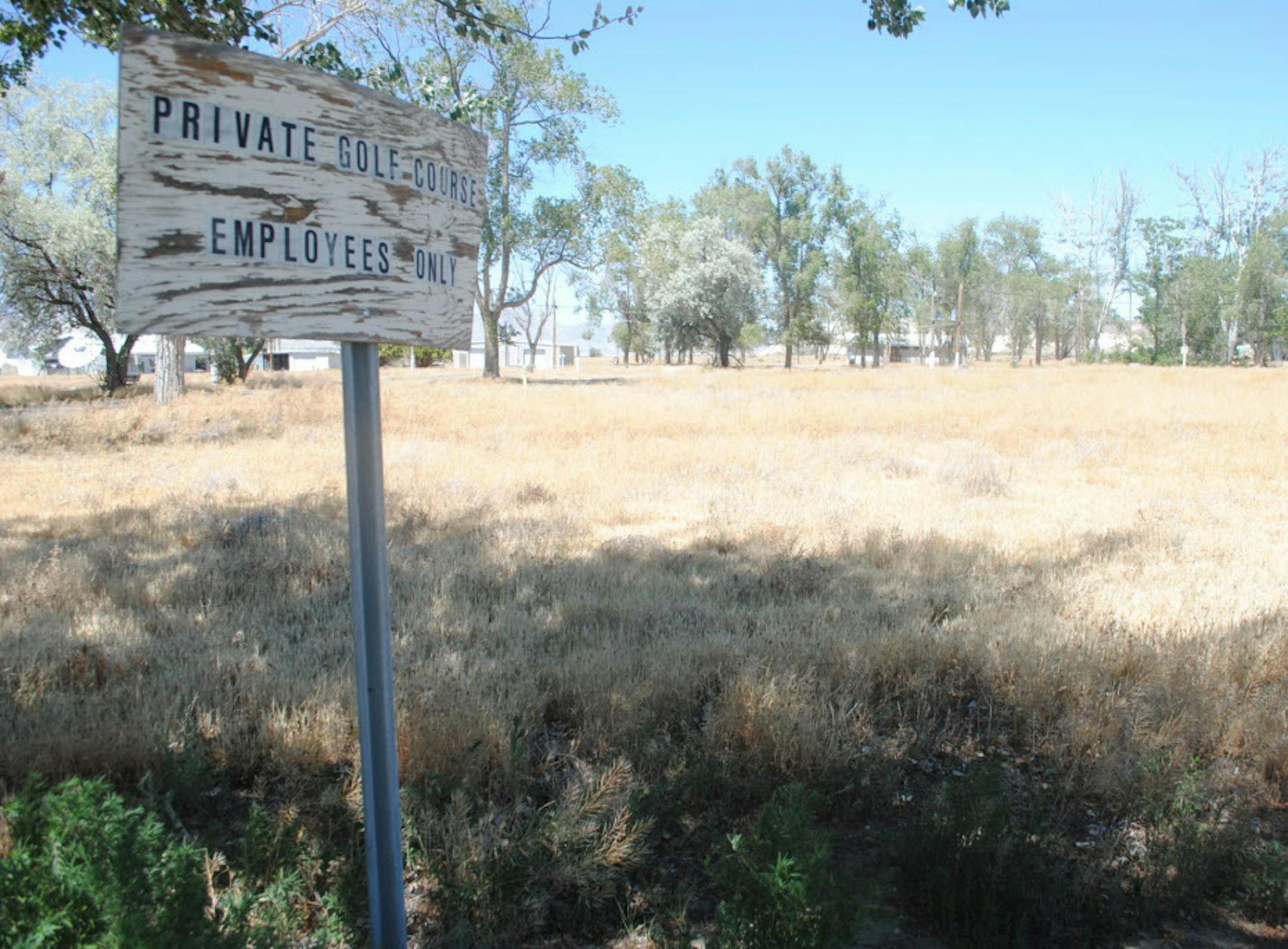 ADVANCE FOR WEEKEND EDITIONS, AUG. 27-28 - This June 23, 2016 photo, shows the abandoned golf course in the town of Empire, Nev., a company town that closed in 2011. The town's new owner, Empire Mining Co., is renovating some of the homes so that employees can live in them. (Jenny Kane /The Reno Gazette-Journal via AP)