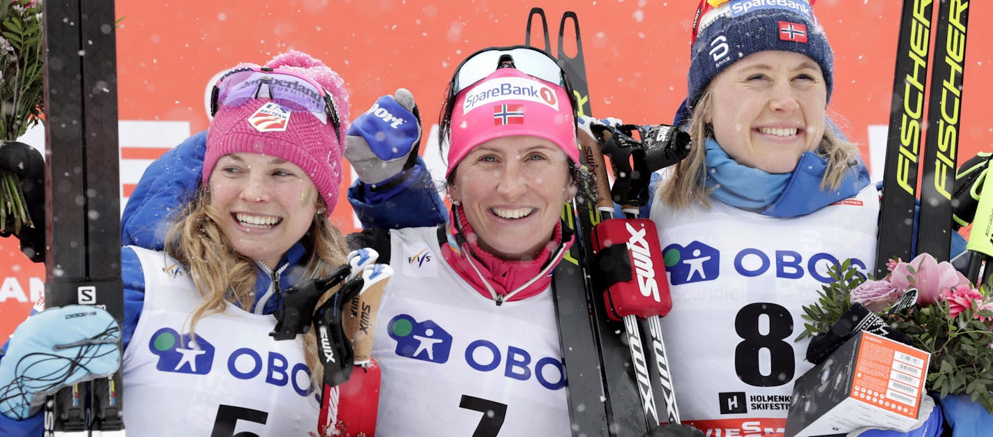 Marit Bjoergen of Norway, center, winner of a cross-country ski, women's World Cup 30k Mass Start event, poses on the podium with second placed United States' Jessica Diggins, left, and third placed Ragnhild Haga, of Norway, in Holmenkollen, Oslo, Sunday, March 11, 2018. (Berit Roald/NTB scanpix via AP)