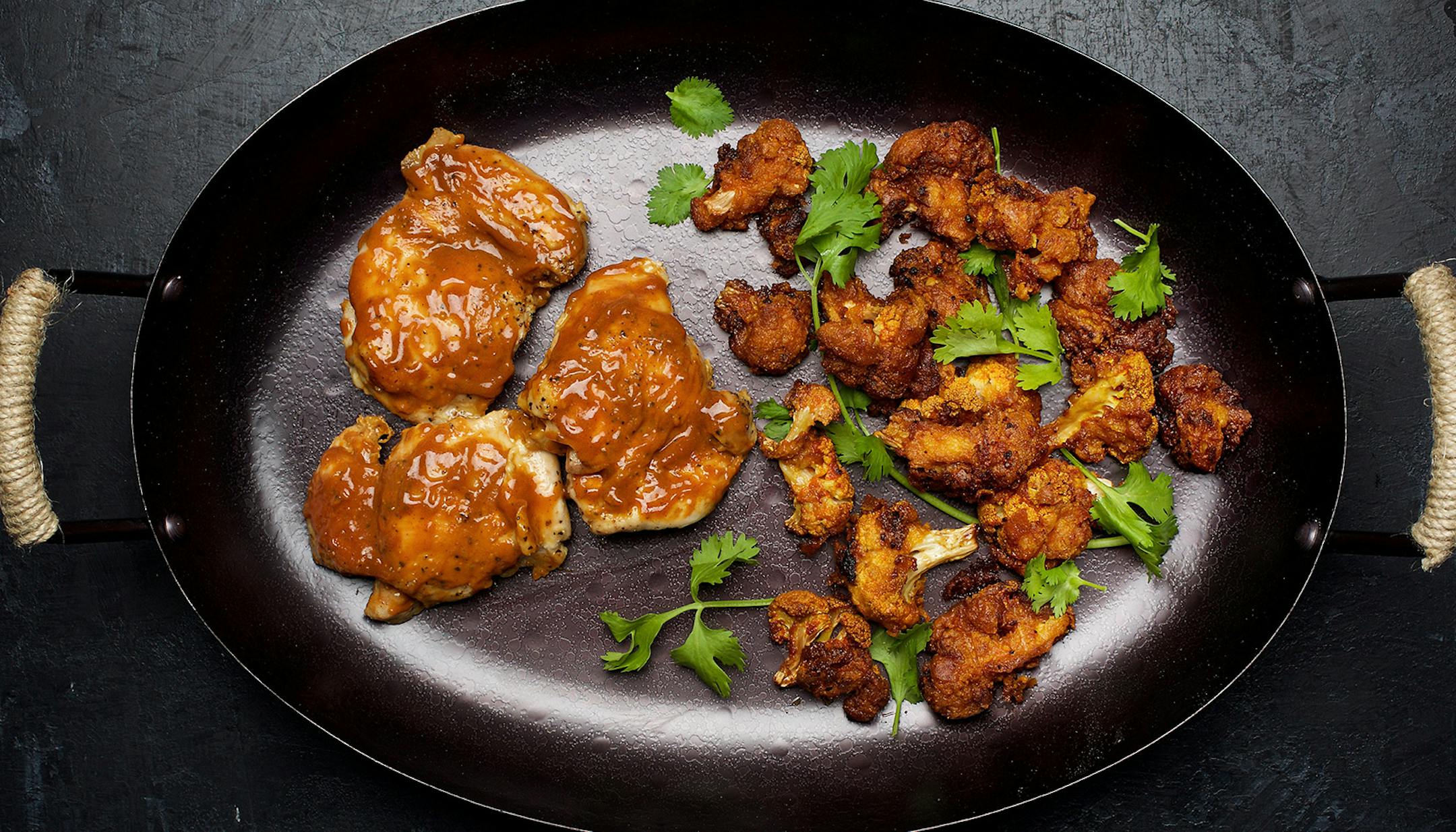 Left to right: Chicken Thighs With Classic American Barbecue Sauce; Cauliflower 65. MUST CREDIT: Photo for The Washington Post by Deb Lindsey. Food styling for The Washington Post by Bonnie S. Benwick