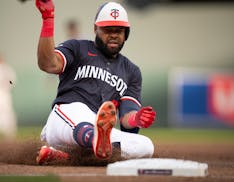 Twins center fielder Manuel Margot slides safely into third base in the third inning, on the Twins' first hit of the game against Colorado's Dakota Hu