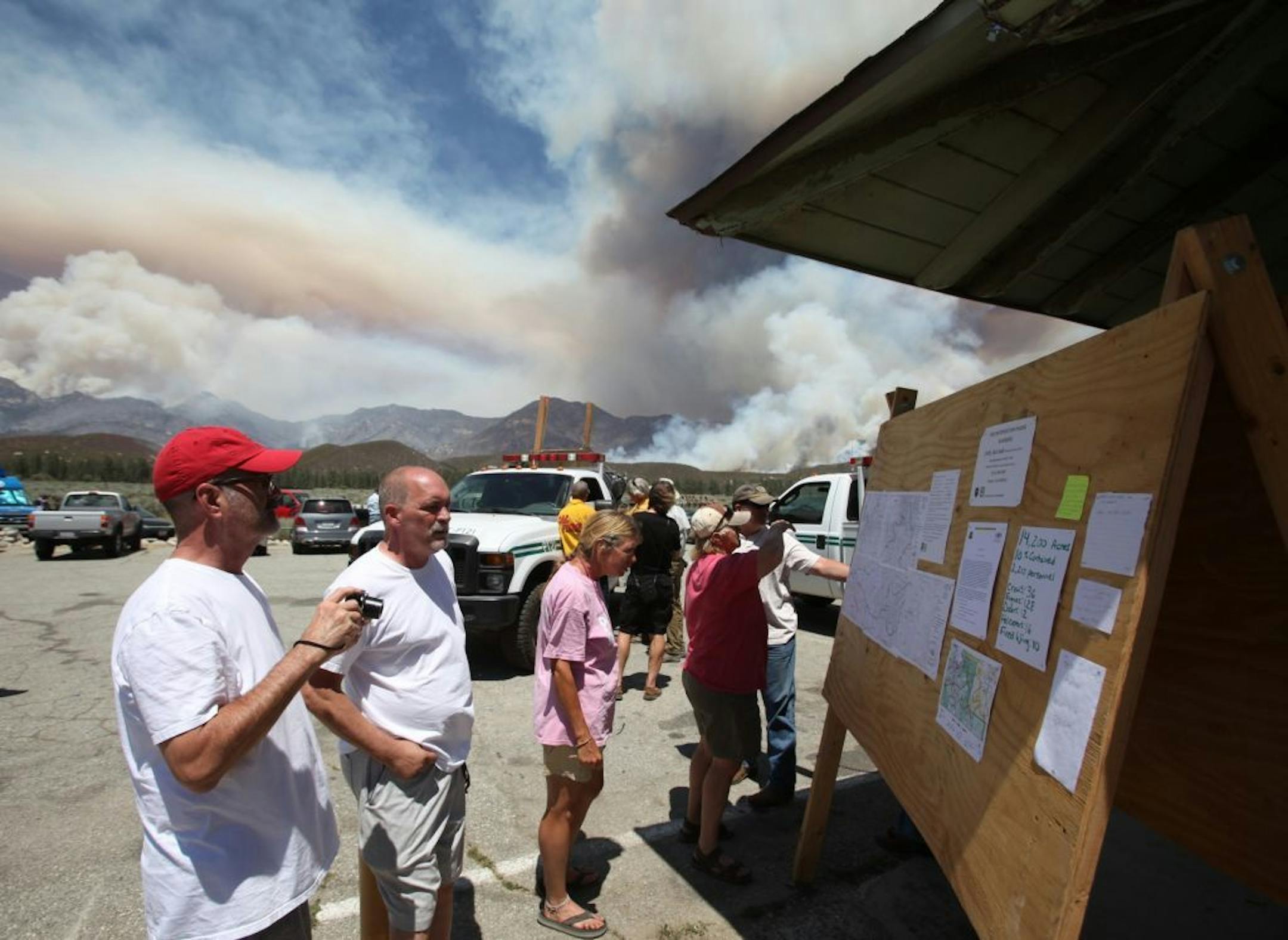Locals read posted notices and updates on the progress against the Mountain Fire near Idyllwild, Calif., Wednesday, July 17, 2013.