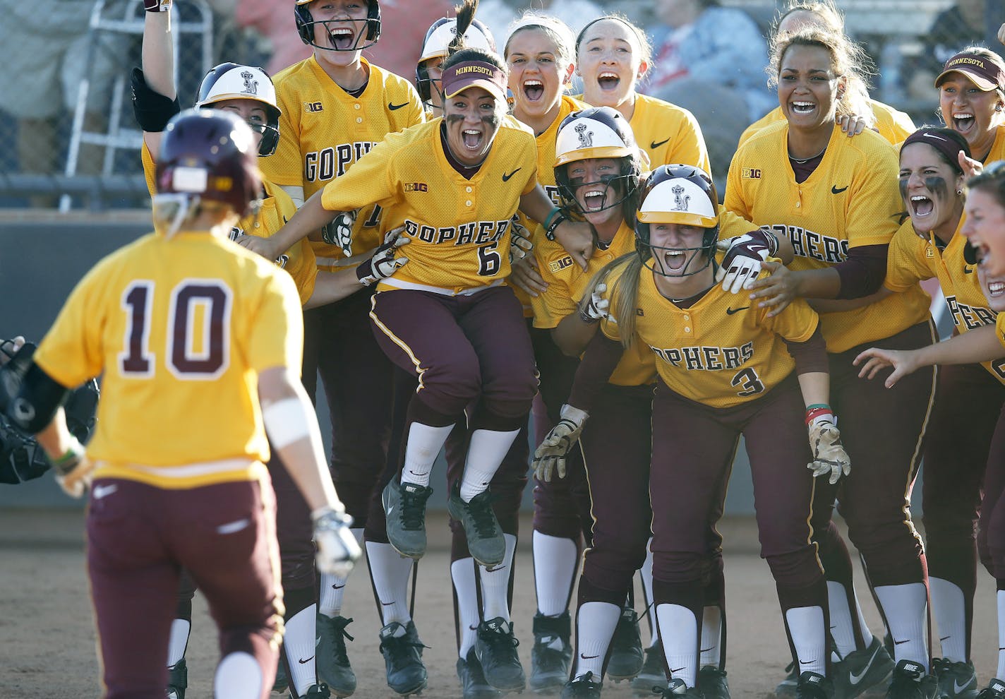 Jubilant Gophers players waited to greet Paige Palkovich (10) after her walk-off grand slam beat Arizona and kept the Gophers alive in the NCAA softball tournament. The Gophers lost in the region final.