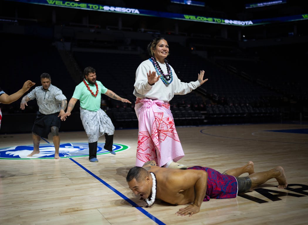Alissa Pili dances with members of the local Samoan community, including former Minnesota Viking and fellow Samoan Esera Tuaolo during the event. He said the gesture of lying down with her foot resting on his back was about “uplifting the princess.”