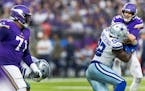 Dorance Armstrong (92) of the Dallas Cowboys pressures Minnesota Vikings quarterback Kirk Cousins (8) as Christian Darrisaw (71) looks on in the first