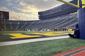 Quarterback J.J. McCarthy sat on the Michigan Stadium field with his back against a padded goalpost Nov. 4. The stadium will be packed Saturday, when 