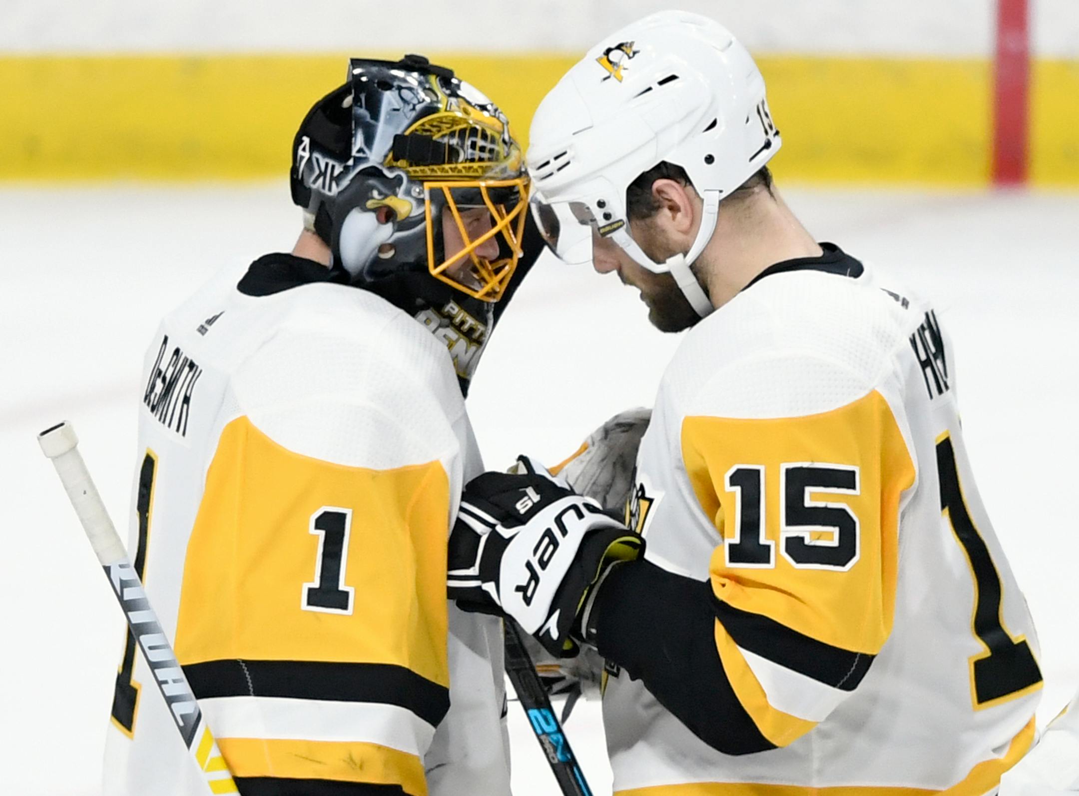 Pittsburgh Penguins goaltender Casey DeSmith (1) and teammate Riley Sheahan (15) celebrate the team's 3-2 win against the Minnesota Wild in an NHL hockey game Monday, Dec. 31, 2018, in St. Paul, Minn. (AP Photo/Hannah Foslien)