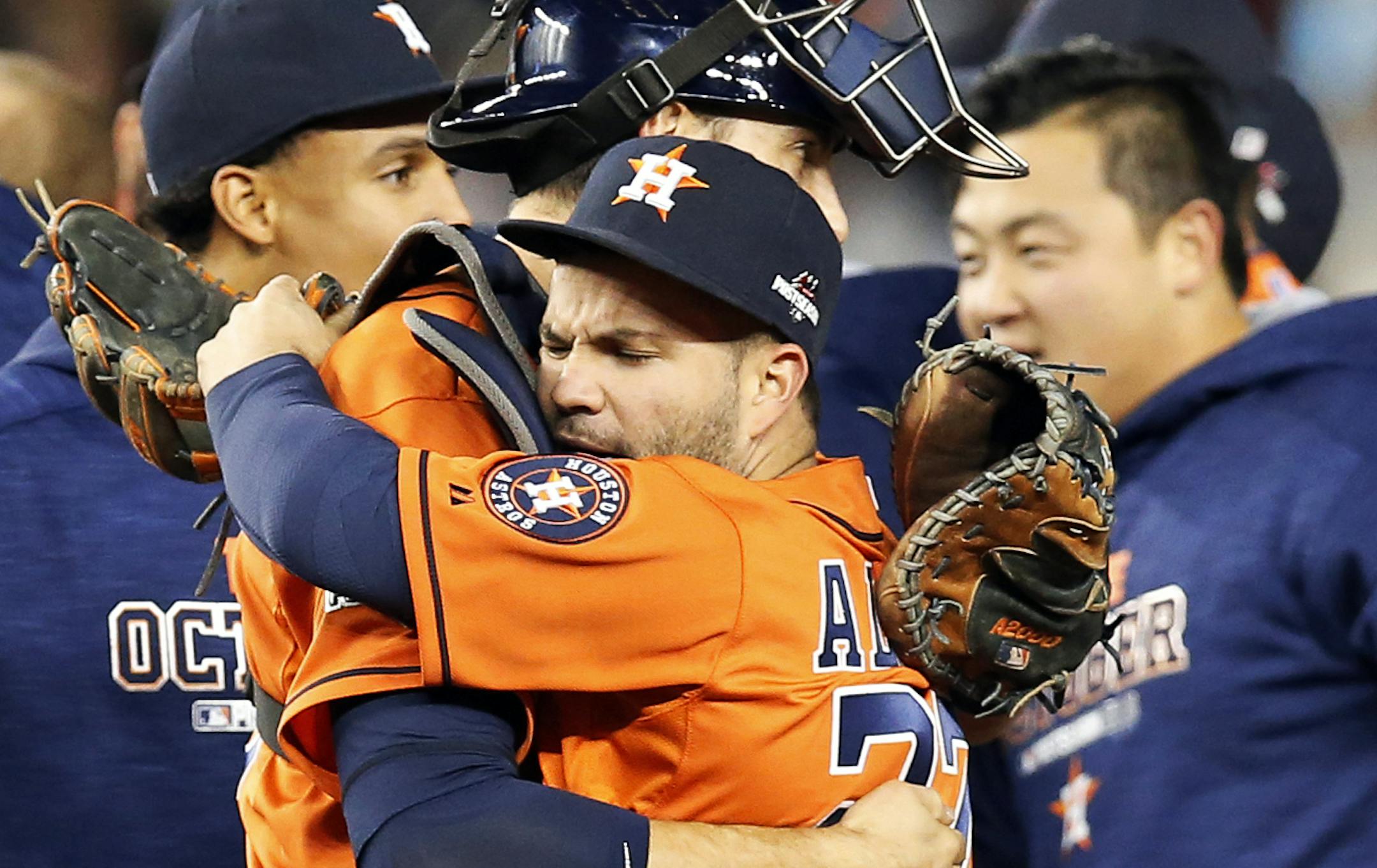 Houston Astros catcher Jason Castro, center left, embraces Astros second baseman Jose Altuve after the Astros beat the New York Yankees 3-0 in the American League wild card baseball game at Yankee Stadium in New York, Tuesday, Oct. 6, 2015. Astros center fielder Carlos Gomez is at left and Hank Conger is at right. (AP Photo/Kathy Willens) ORG XMIT: NYY138