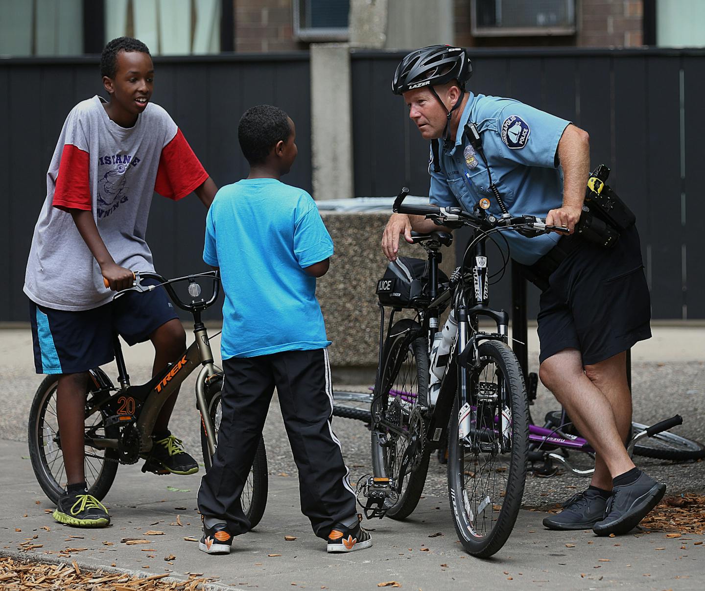 Minneapolis police officer Mike Kirchen chatted with Mascud Abdi, 13 (left), and Mahad Ahmed, 10, while on patrol in the Cedar Riverside neighborhood.