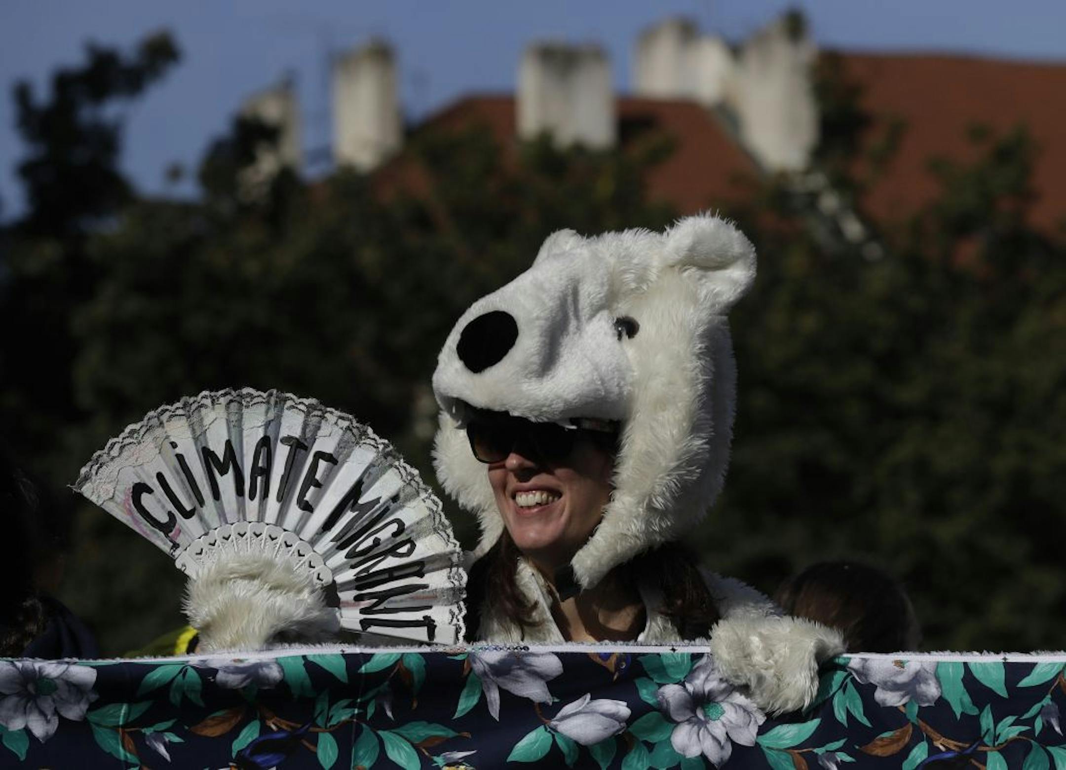A girl wearing a polar bear costume joins a protest at the Old Town Square in Prague, Czech Republic, Friday, Sept. 20, 2019. Several hundreds of protestors gathered in response to a day of worldwide demonstrations calling for action to guard against climate change.