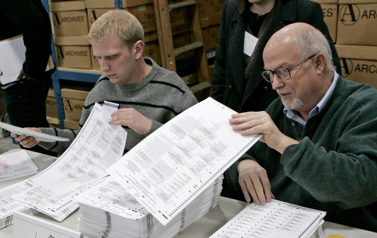 FILE - In this Nov. 19, 2008 file photo, election judges Edwin Holmvig-Johnson, left, and Bob Filipek sort Minneapolis ballots during the recount process in the U.S. Senate race between Republican Sen. Norm Coleman and Democrat Al Franken in Minneapolis. Democrat Mark Dayton and Republican Tom Emmer were in a too-close-to-call race that stirred memories of the state's bitterly contested 2008 U.S. Senate election. (AP Photo/Jim Mone, File)