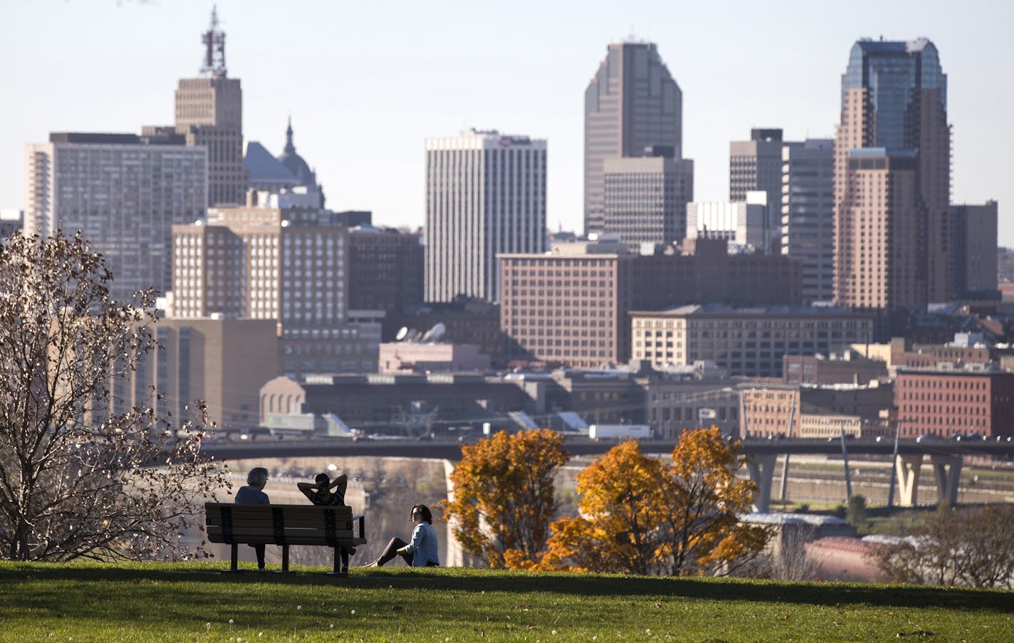 Enjoying a clear view of downtown St. Paul, Margaret Churchill, from left, Hasnaa El Hannach, and Pamela Zamora relax at Indian Mounds Park in St. Paul. ] (Leila Navidi/Star Tribune) leila.navidi@startribune.com BACKGROUND INFORMATION: Beautiful weather at Indian Mounds Park in St. Paul on Friday, November 4, 2016. This weekend will see high temperatures in the mid to high 60s, approaching record setting weather for this time of year. ORG XMIT: MIN1611041524171053