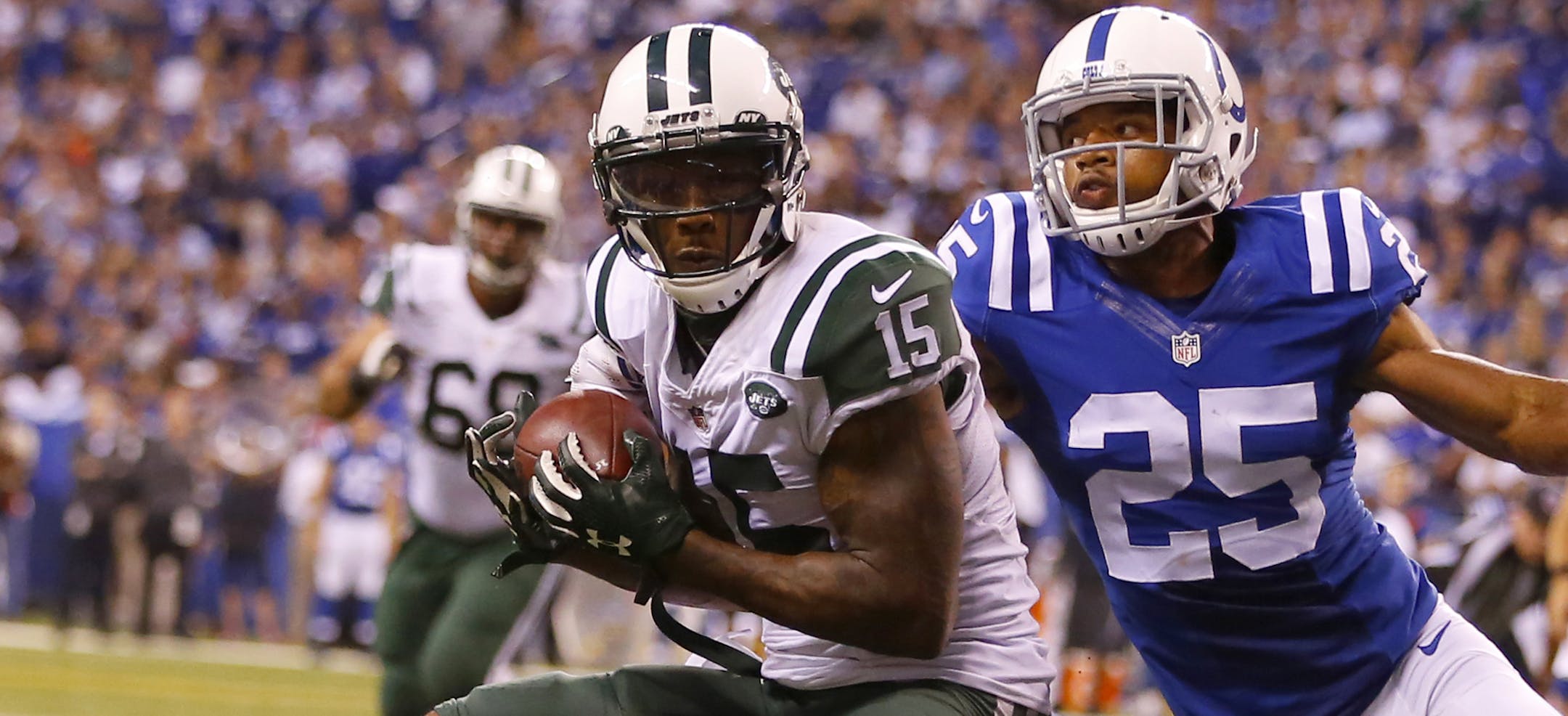 New York Jets wide receiver Brandon Marshall (15) catches a touchdown pass as Indianapolis Colts defensive back Jalil Brown (25) tries to defend during an NFL football game in Indianapolis, Monday, Sept. 21, 2015. (Jeff Haynes/AP Images for Panini)