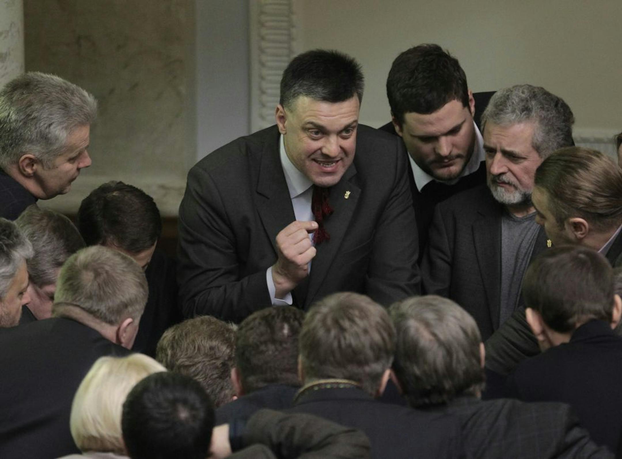 Ukrainian opposition leader Oleh Tyahnybok, center, talks to lawmakers in the parliament session hall, in Kiev, Ukraine, Tuesday, Jan. 28, 2014.