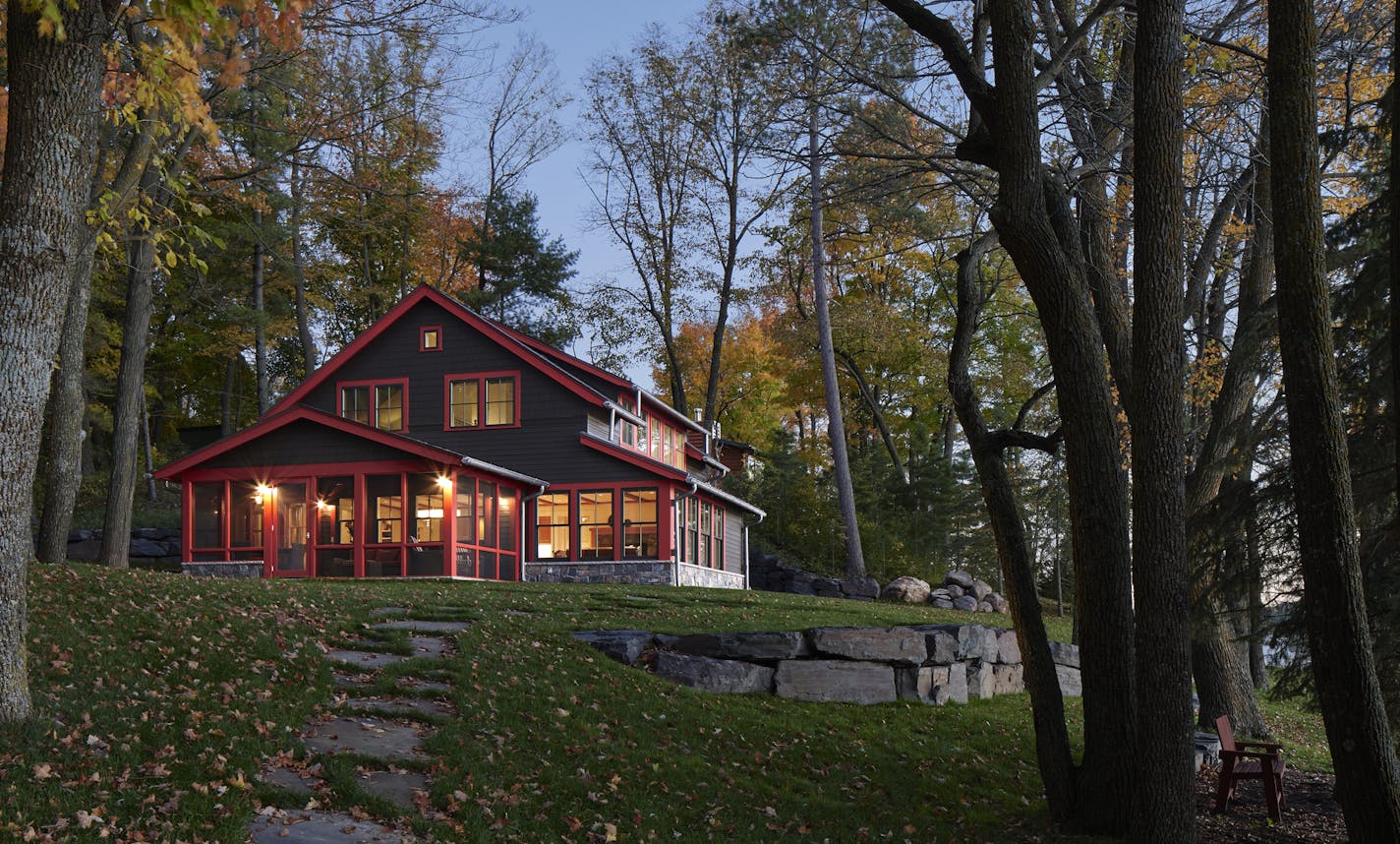 An understated roofline and dark shingles help this cabin melt into the landscape.