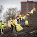 State employees pick up trash on a hill behind the Minnesota Pollution Control Agency building during the Lafayette Park neighborhood clean-up.