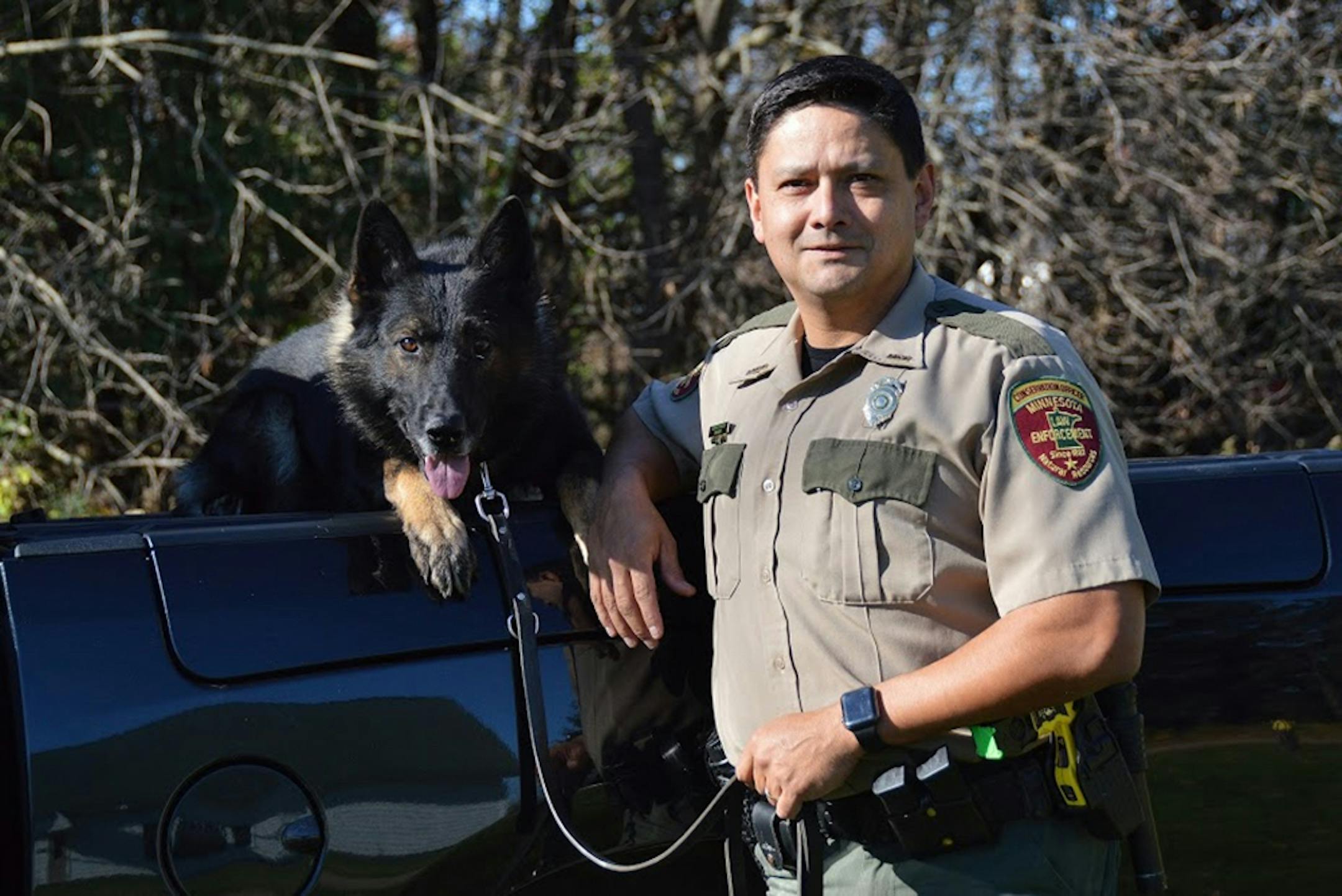 Conservation officer Scott Staples, right, shown with his partner Schody. Schody will retire from duty Thursday.