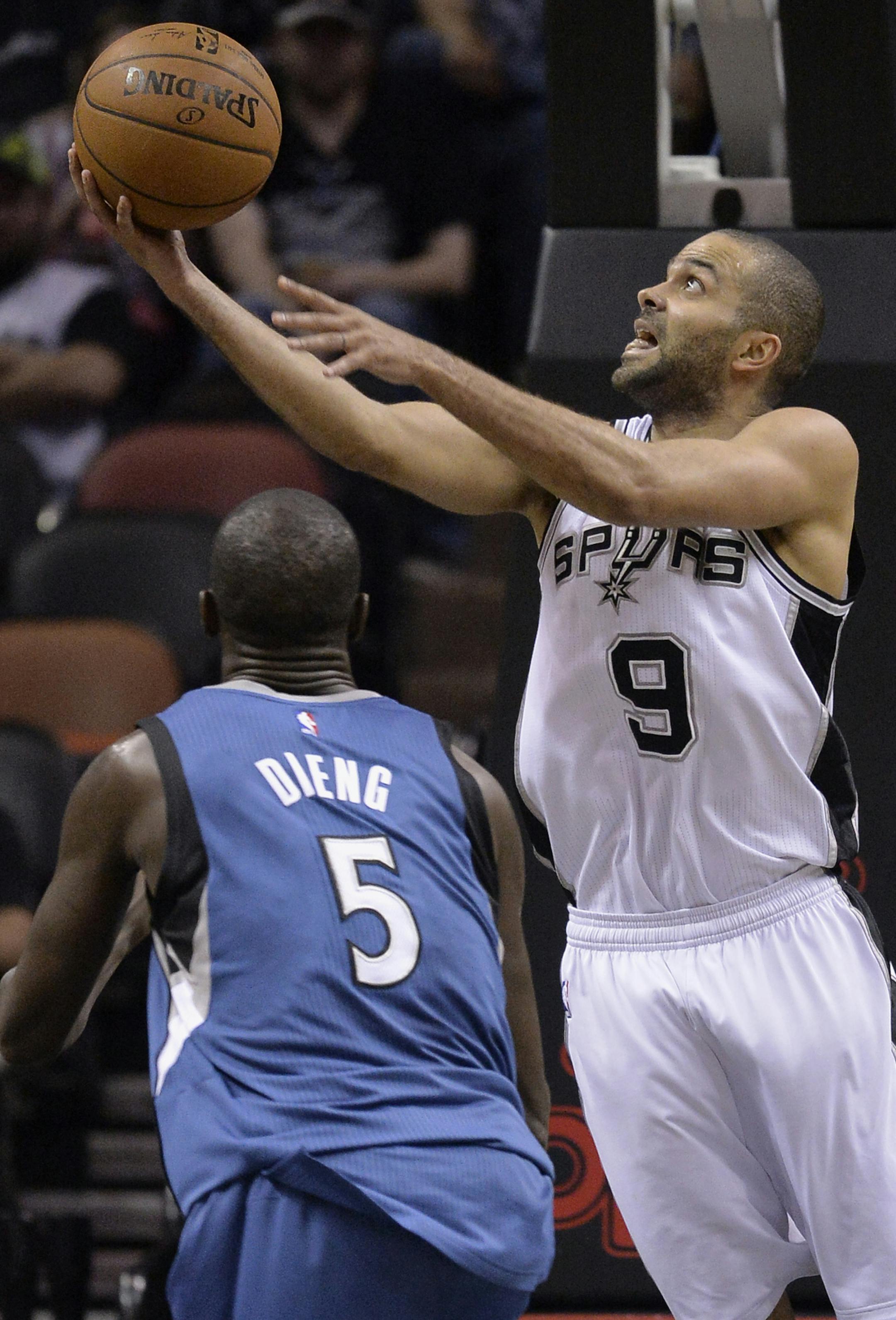 San Antonio Spurs guard Tony Parker (9), of France, shoots against Minnesota Timberwolves center Gorgui Dieng, of Senegal, during the first half of an NBA basketball game, Sunday, March 15, 2015, in San Antonio. (AP Photo/Darren Abate)