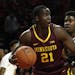 Minnesota center Bakary Konate looks for a teammate as he is pressured by Maryland guard Darryl Morsell, right, during the first half of an NCAA colle