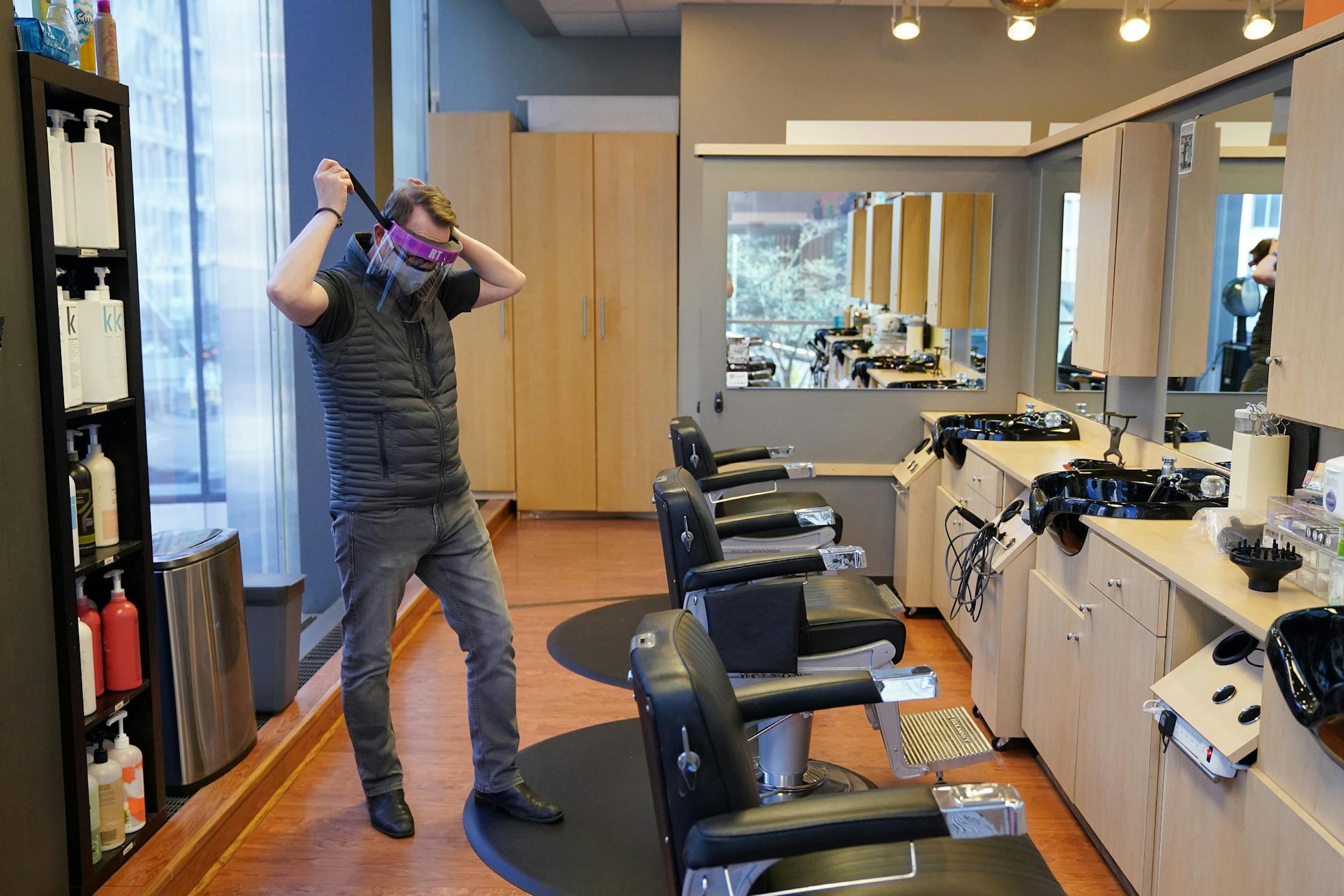 Tom Ford, owner of the Madison & Co Salon in the Canadian Pacific building, donned one of the protective face shields he'd ordered to wear while cutting hair as he stopped in to get the mail and check in on the space Wednesday.