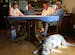 Joseph Zacher's family sits around the "Jefferson roundtable," as they like to call it, in the home of Tom Jefferson in Birchwood Village, Minn. (From