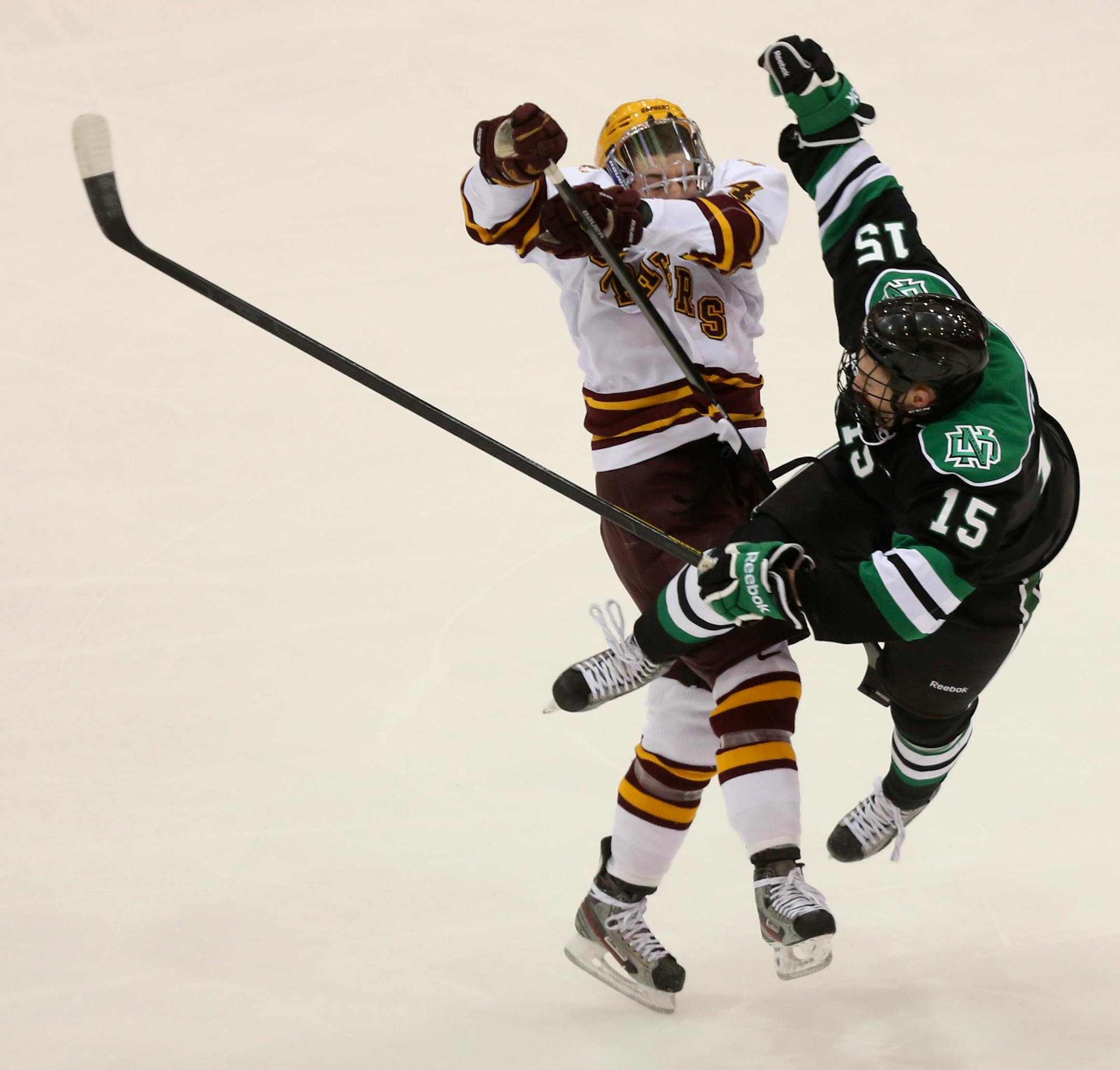 Minnesota's Tom Serratore checked North Dakota's Michael Parks off the puck during the first period at Mariucci Arena on January 19, 2013.
