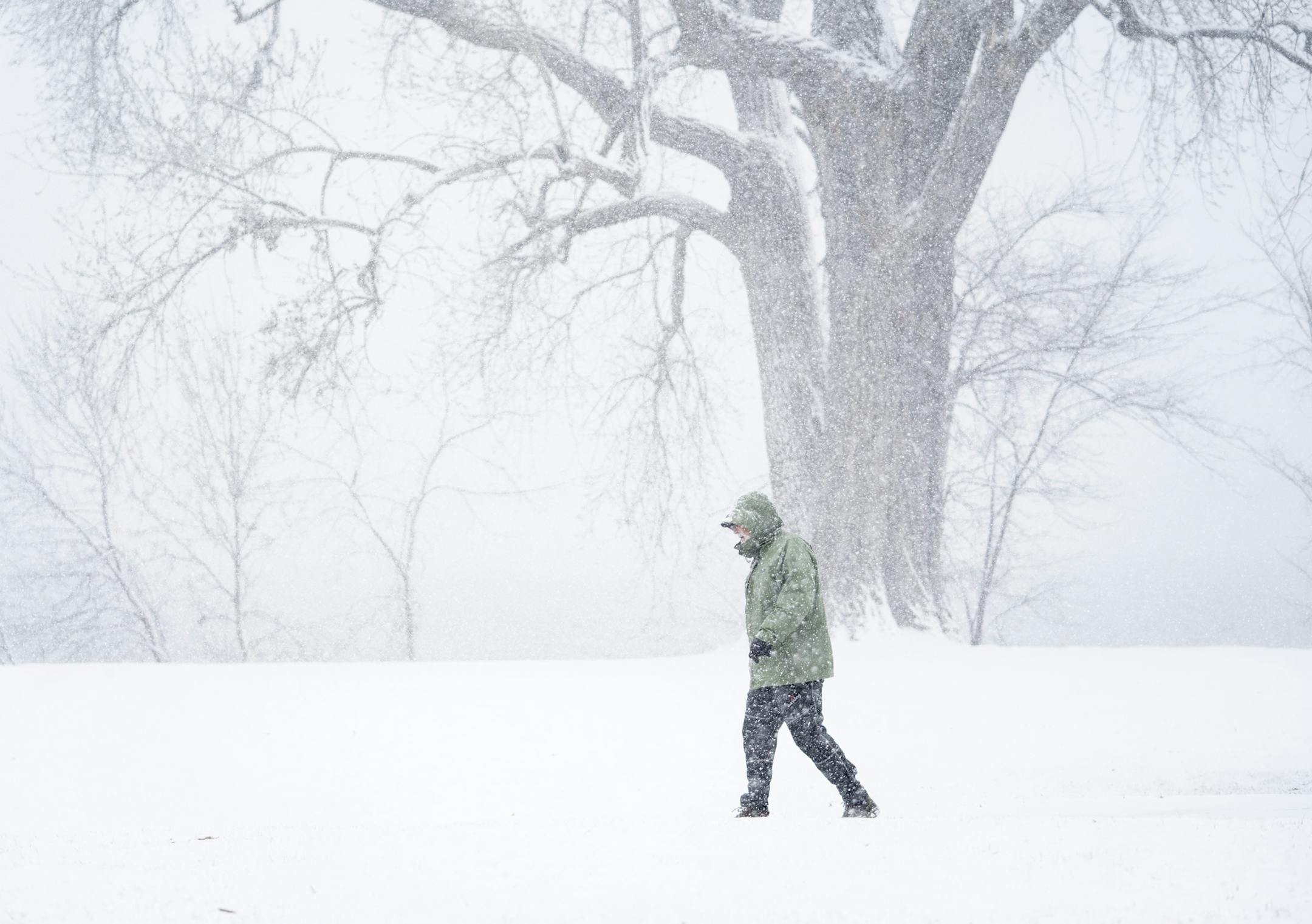 Scott Boie took his daily walk around Lake Nakomis in the snow Minneapolis, Minn., on Wednesday, April 10, 2019. "There is no such thing as bad weather only inappropriate clothing," said Boie of the weather. ] RENEE JONES SCHNEIDER &#x2022; renee.jones@startribune.com