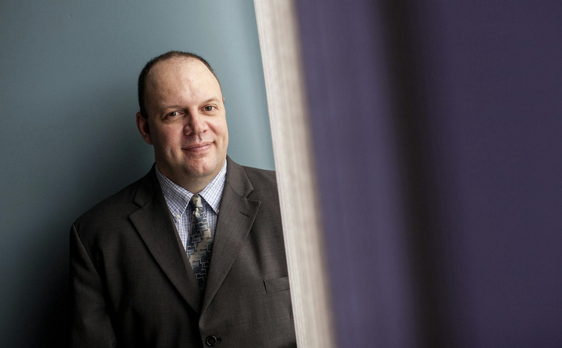 Jeremy Redlinger, branch manager and loan officer for Midwest Mortgage Capital, works solo in a sparsely-furnished, rented office in Maple Grove September 20, 2013. The independent mortgage bank, which is based in St. Louis, MO, will be opening a new office in downtown Osseo in November. (Courtney Perry/Special to the Star Tribune)