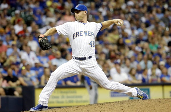 Milwaukee Brewers relief pitcher Neal Cotts throws during the sixth inning of a baseball game against the Chicago Cubs Friday, July 31, 2015, in Milwa