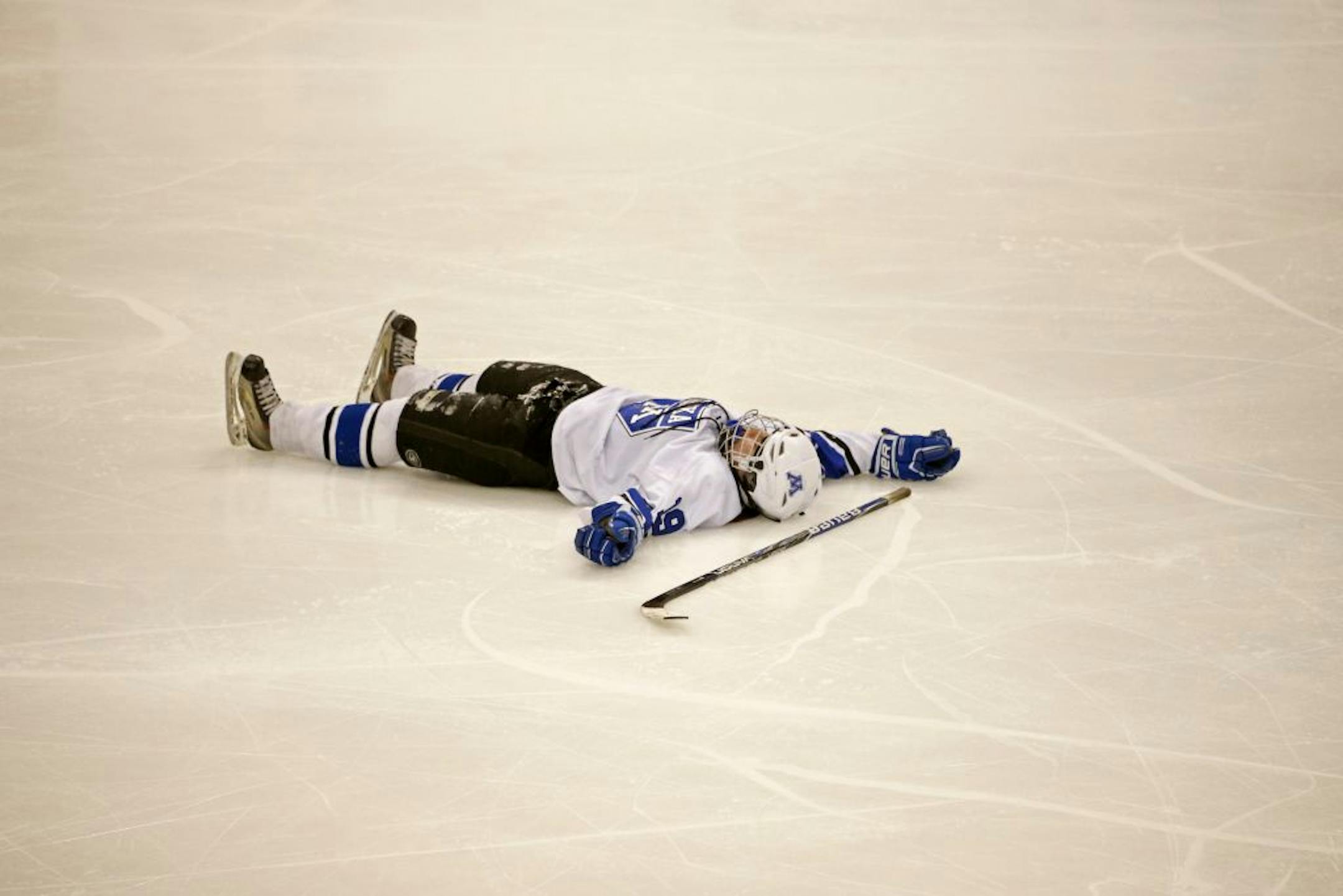 It was the longest game in Minnesota high school hockey history, 4 hours 15 minutes and 9 periods. Here, Minnetonka's Kelsey Crow lays on her back after the victory over Lakeville North.