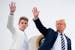 U.S. President Donald Trump and his son Barron wave as they board Air Force One at Morristown Municipal Airport in Morristown, New Jersey, on Aug. 16,
