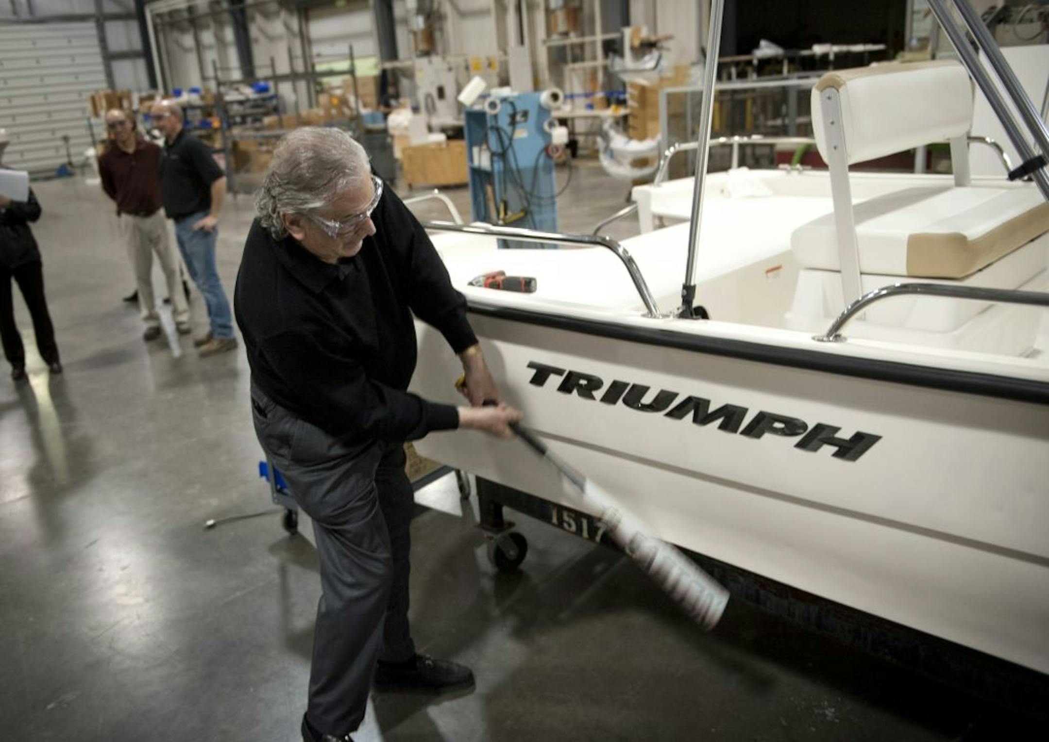 Larson Boats owner Irwin Jacobs took a swing at a Triumph boat with an aluminum bat to show how tough the boat's molded polymer hull is.