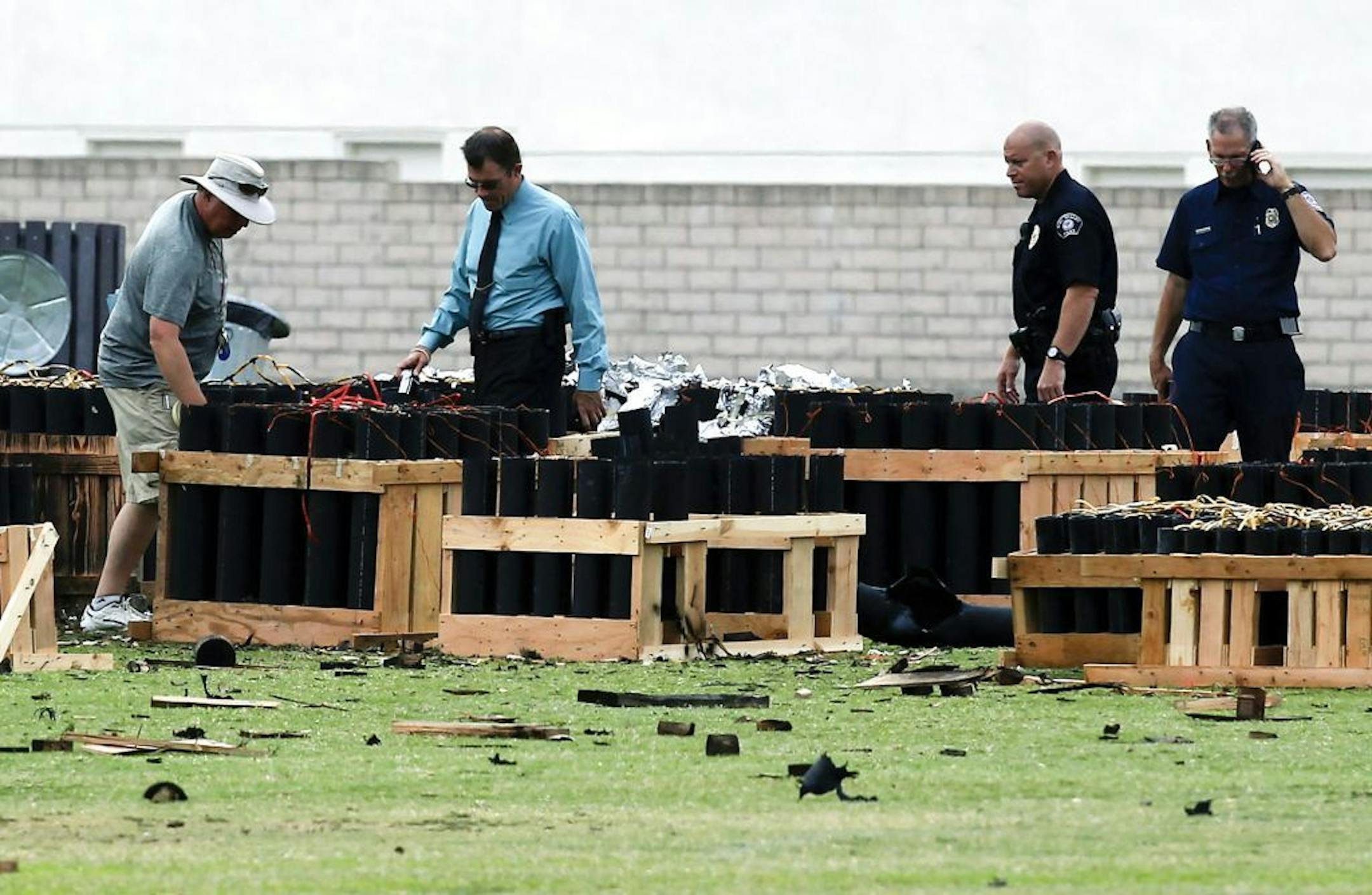 Police officials investigate a site in Simi Valley, Calif., Friday July 5, 2013 where an explosion Thursday injured more than two dozen people at a fireworks display. The explosion occurred when a wood platform holding live fireworks tipped over, sending the pyrotechnics into the crowd of spectators.