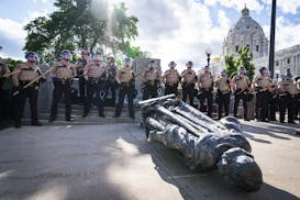 State Troopers surrounded the statue of Christopher Columbus after it was toppled in front of the Minnesota Capitol on June 10.