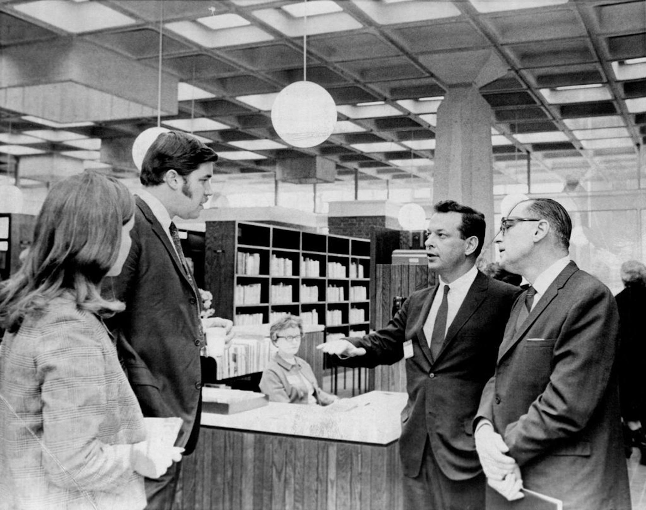 Mayor Arthur Naftalin, right, and Rep. Don Fraser, D-Minn., spoke with Dick Williams and his wife, Mary, left, after dedication ceremonies in February 1968 at the Southeast Branch Library, 1222 SE. 4th St. Williams, with Ralph Rapson Architects Inc., was designer on the remodeling project that converted the building from a State Capitol Credit Union office into a library.