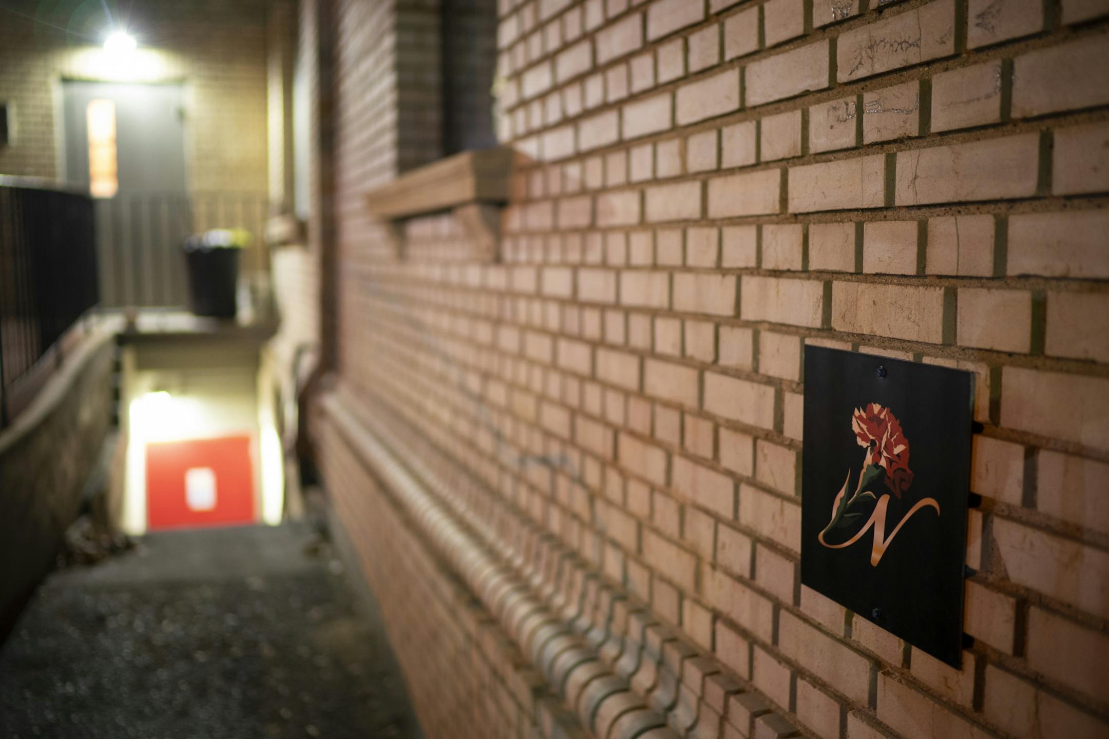 The discrete logo for Nucky's Speakeasy near the basement entrance to the bar.