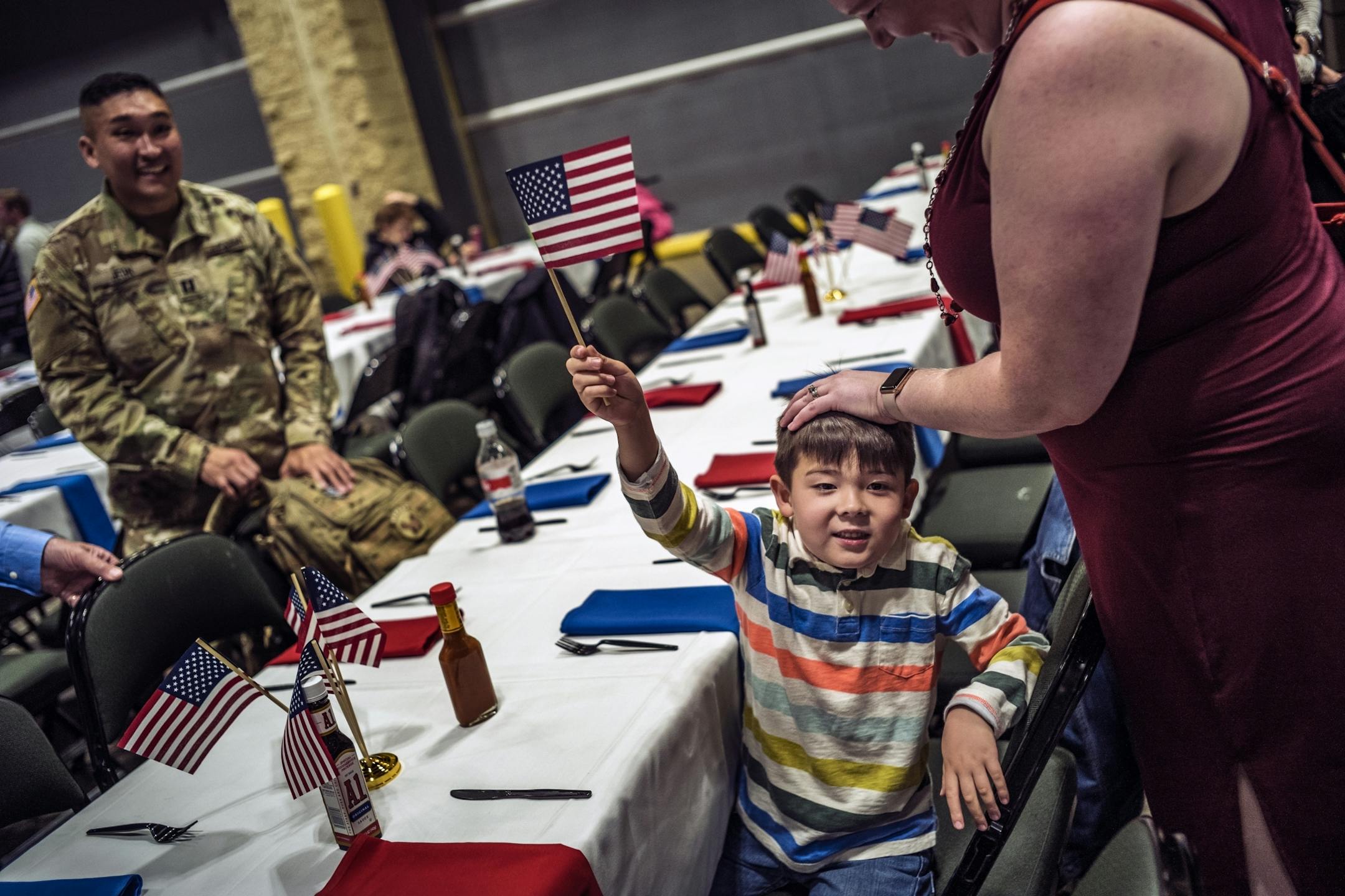 Andrew Jeon,4, waved the American flag as his dad Pil Jeon, a captain and his mother Hilary found a table for the family. They were part of a diner where 5500 meals were were served.