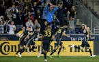 Philadelphia Union's Keegan Rosenberry, right, celebrates ahead of his teammates after scoring during the second half of an MLS soccer match against t