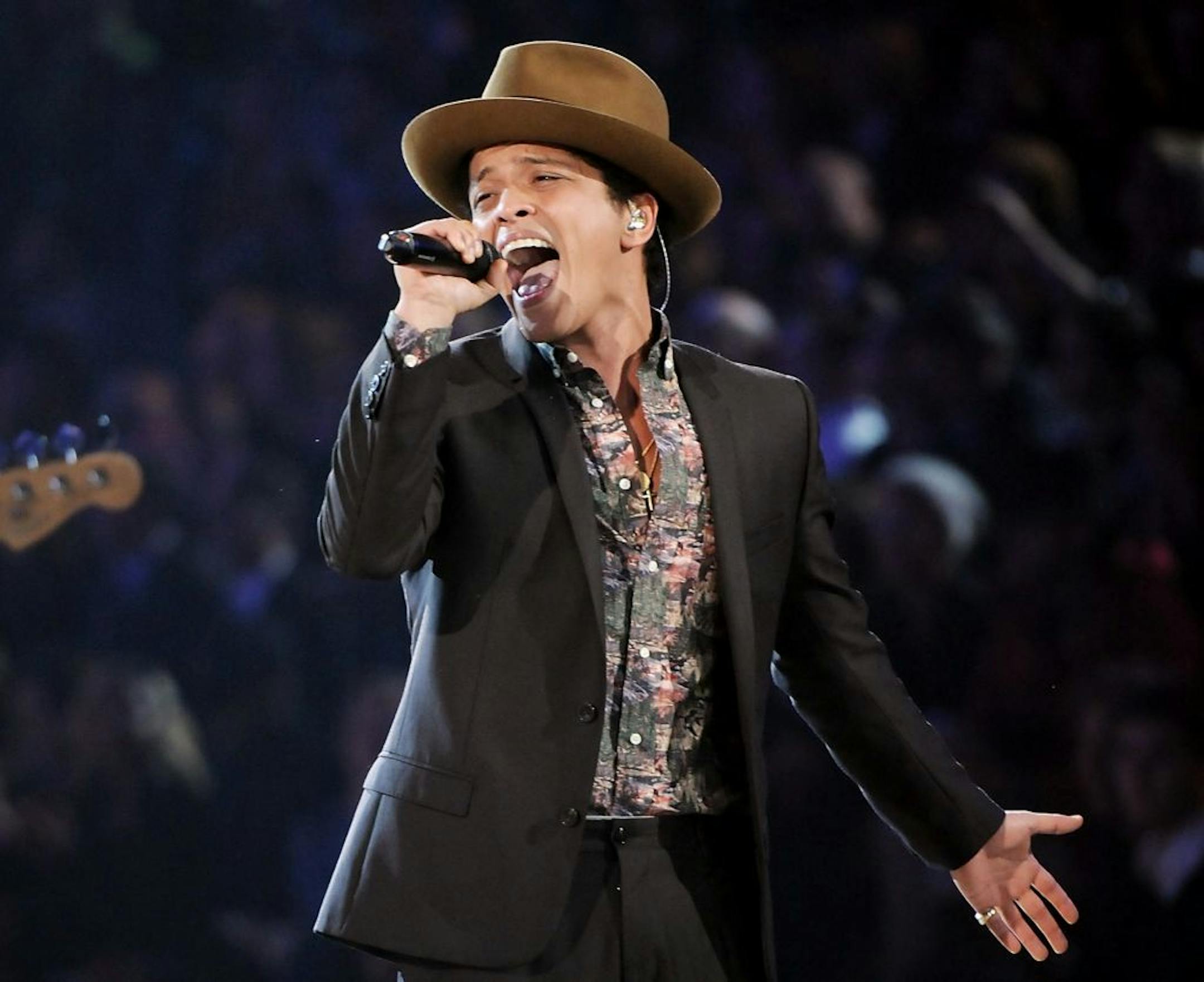 FILE - In this Nov. 7, 2012 file photo, Bruno Mars performs during the 2012 Victoria's Secret Fashion Show in New York. Las Vegas is set to ring in 2014 with big-name concerts, celebrity-hosted parties and an eight-minute rooftop fireworks display billed as the nation's largest. Mars is christening the Cosmopolitan's new Chelsea Ballroom. The show will be broadcast live on the casino's 65-foot (20-meter) marquee to ice skaters at a rooftop rink and partyers on the Strip below. (Photo by Evan Ago