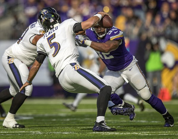 Vikings Tom Johnson closes in on Ravens quarterback Joe Flacco for the sack in the 2nd quarter. ] Minnesota Vikings -vs- Baltimore Ravens US Bank Stad
