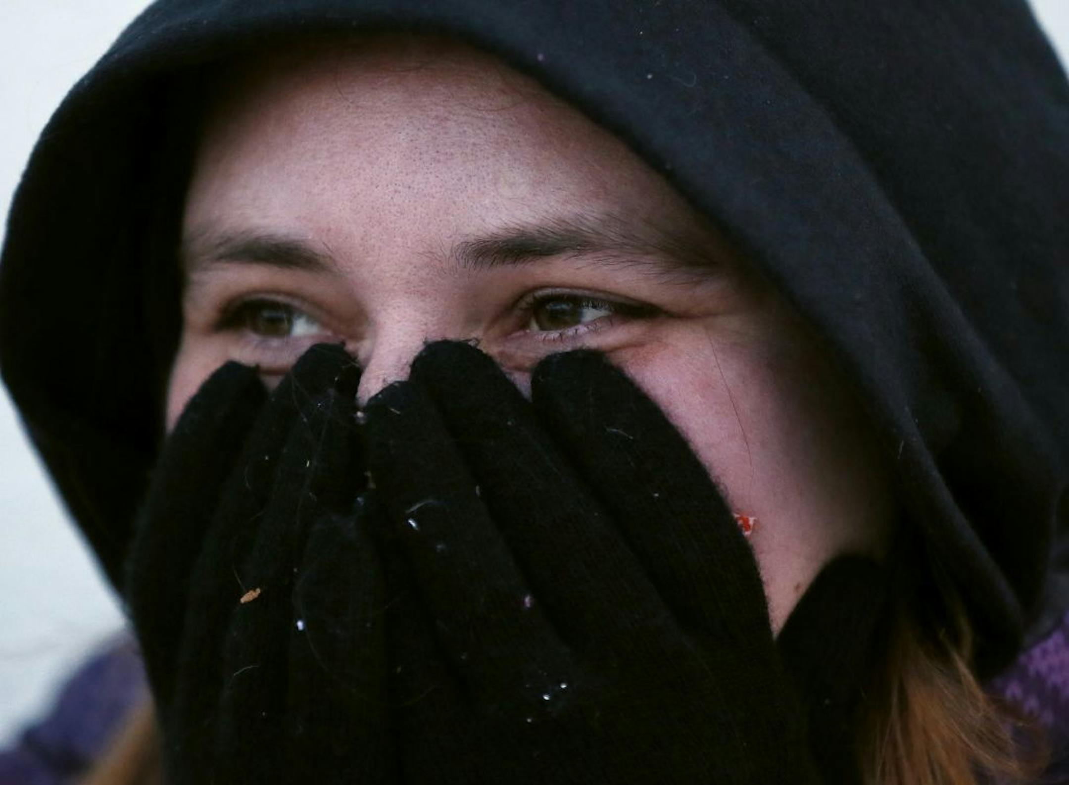 Ashli Bresina try to keep warm as she waited for Toys R Us to up at 5pm Thursday November 27, 2014 in Bloomington, MN.